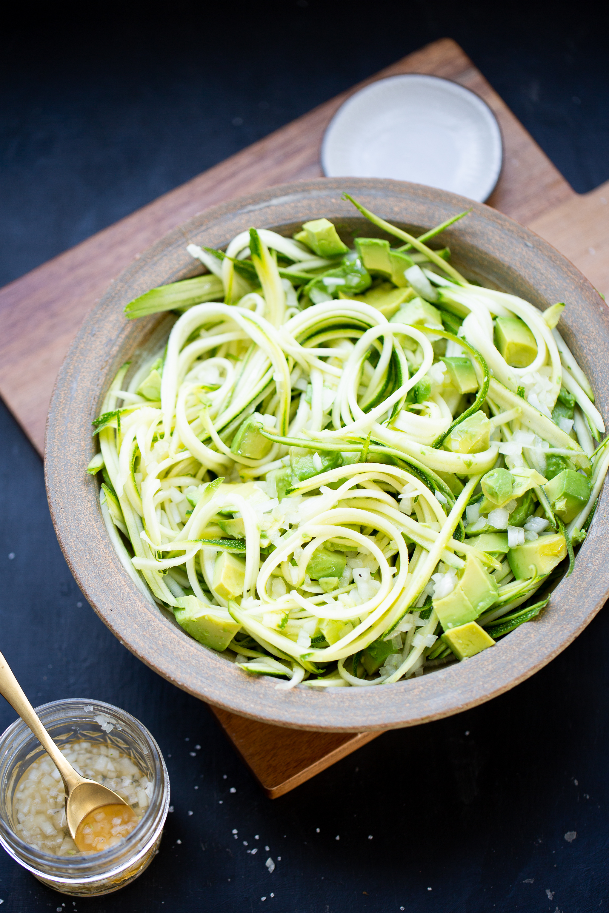 avocado and zucchini salad in a brown salad bowl