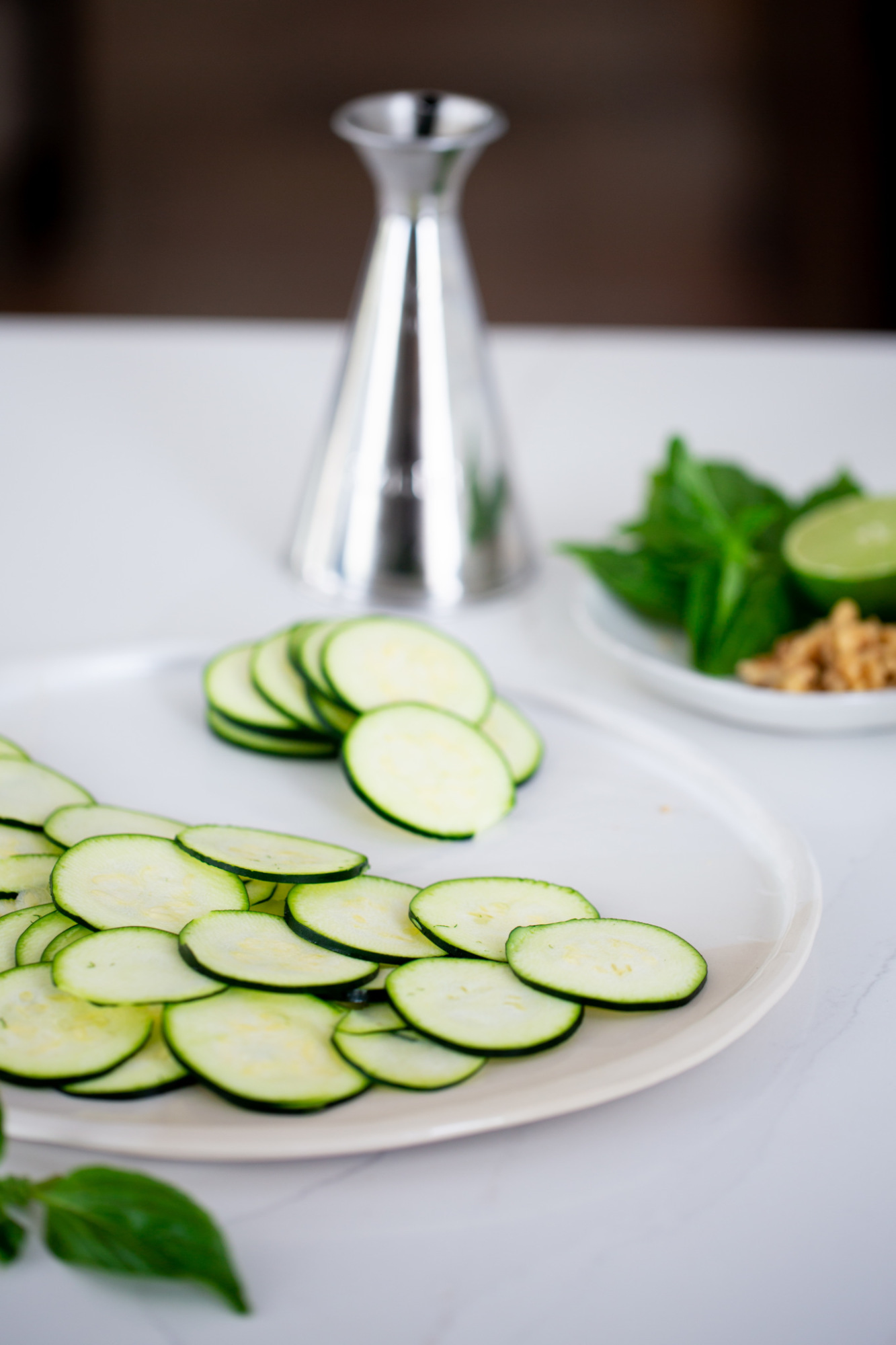 thinly sliced zucchini on a white platter