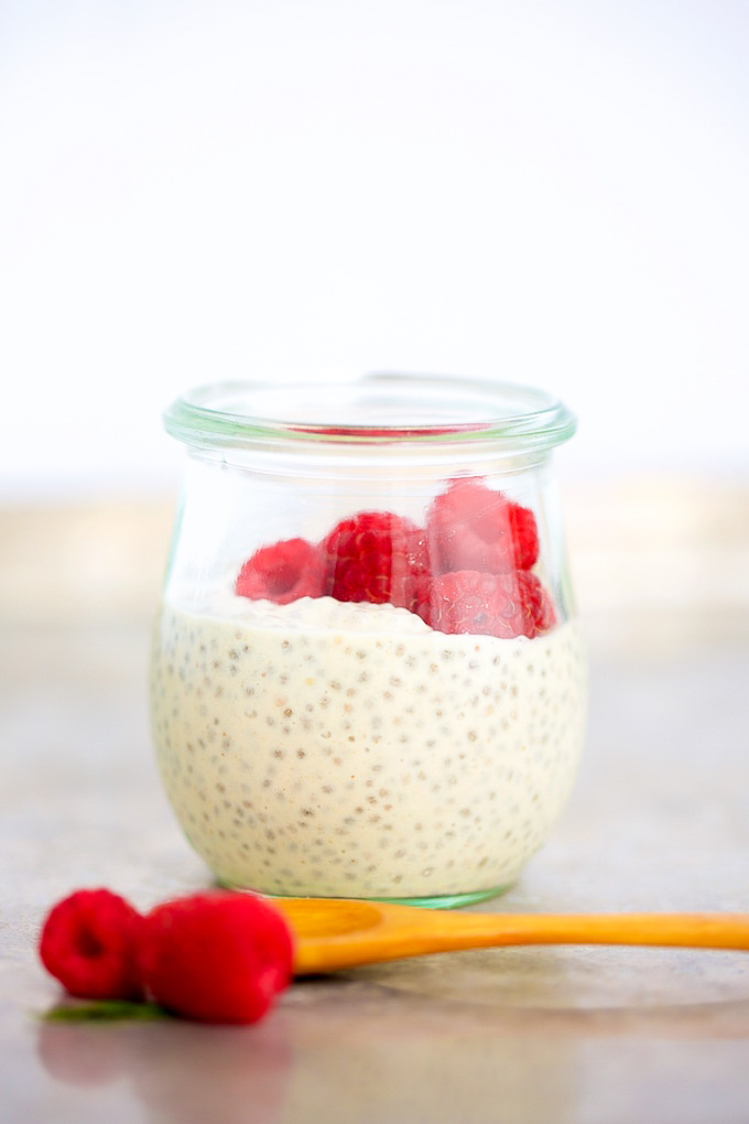 chia pudding in a jar topped with raspberries