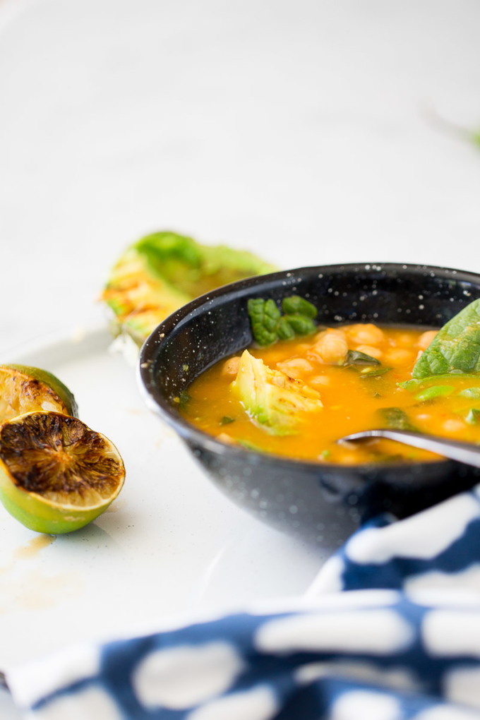 Chickpea soup with roasted avocado and charred lime
