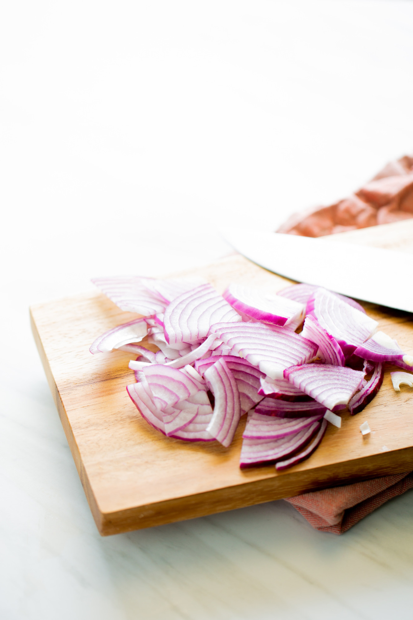 Sliced red oinion on a cutting board