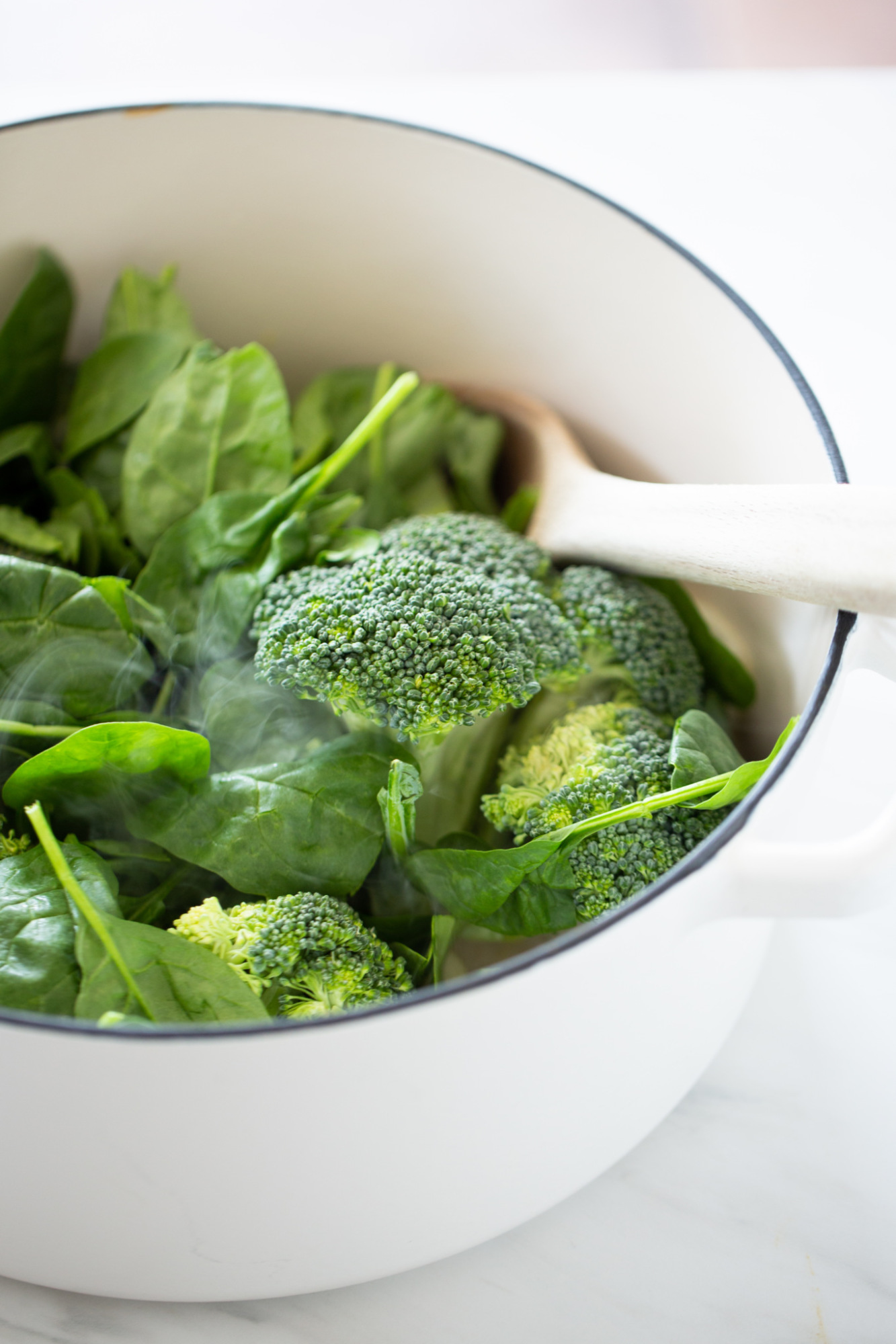 Broccoli and spinach in a soup pot