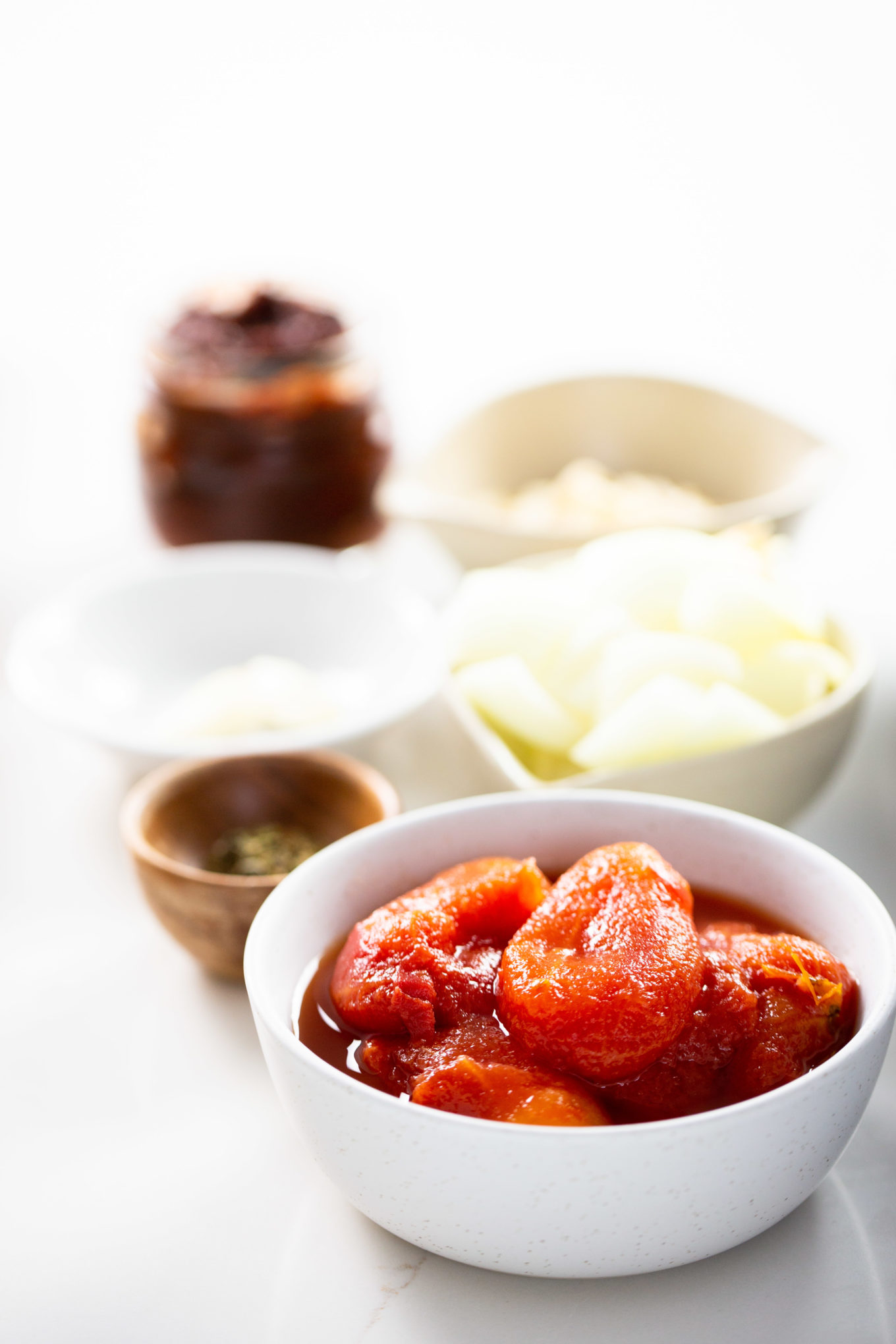 Canned tomatoes in a white bowl for soup