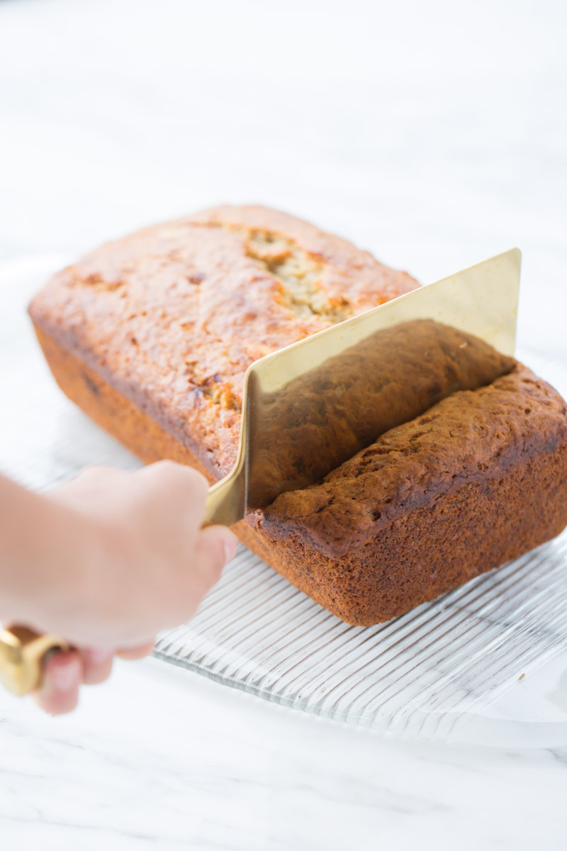 cutting a slice of banana bread