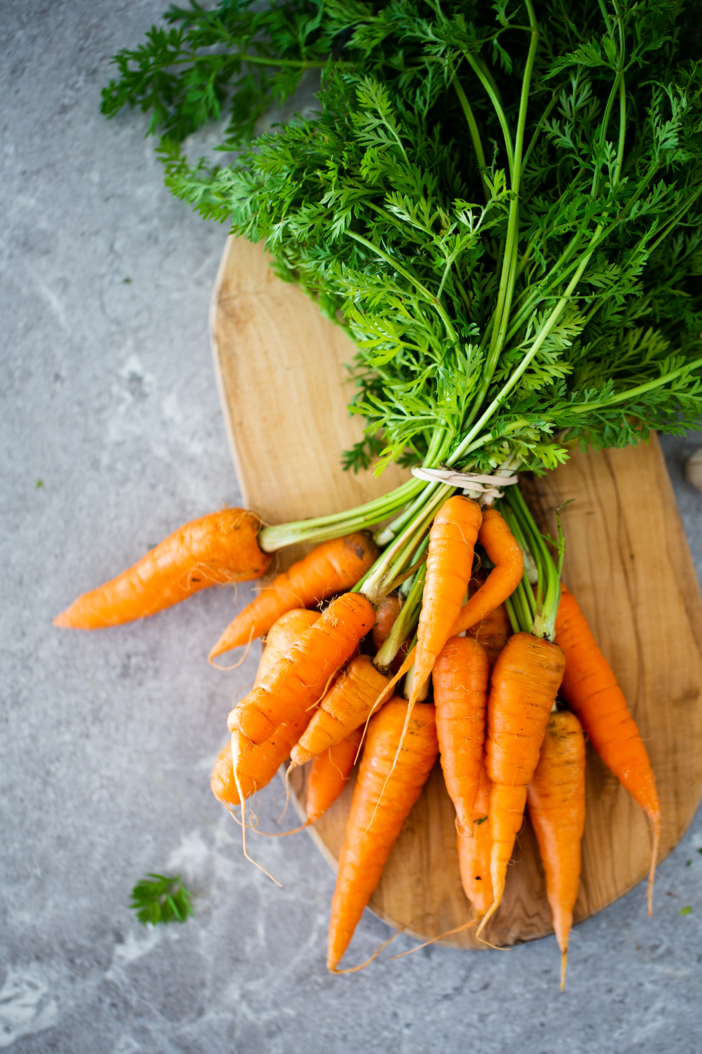 bunch of carrots over chopping board