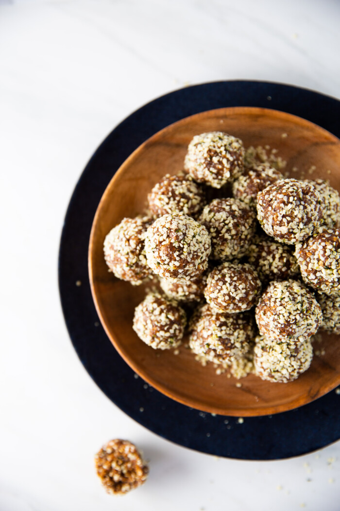 Powerful vegan energy balls on a wooden plate.