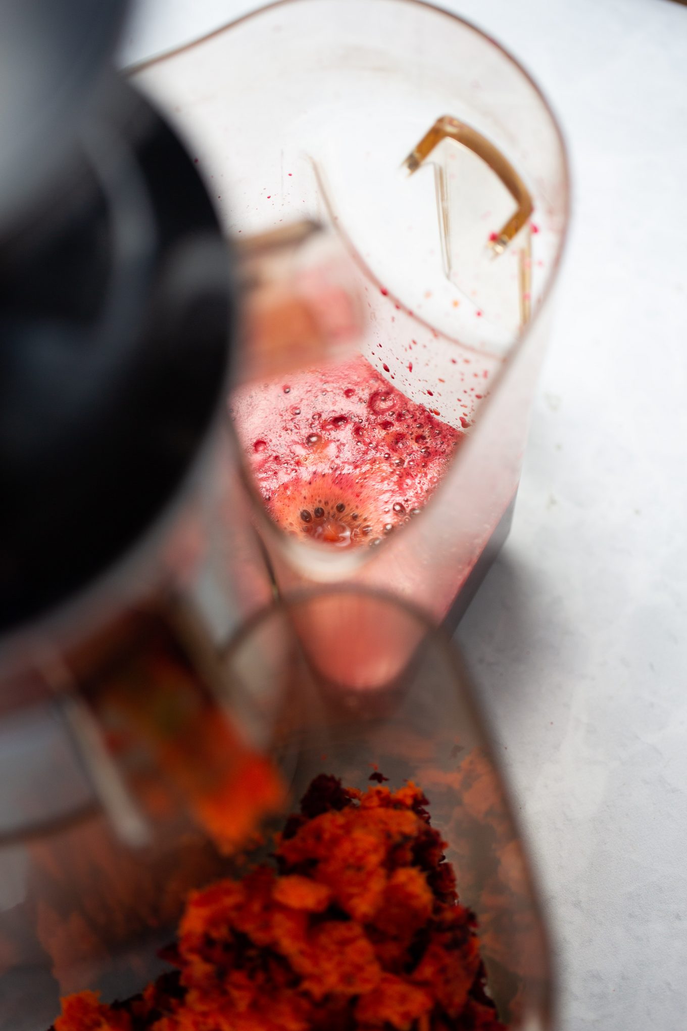 beet juice drops coming out of the juicer.