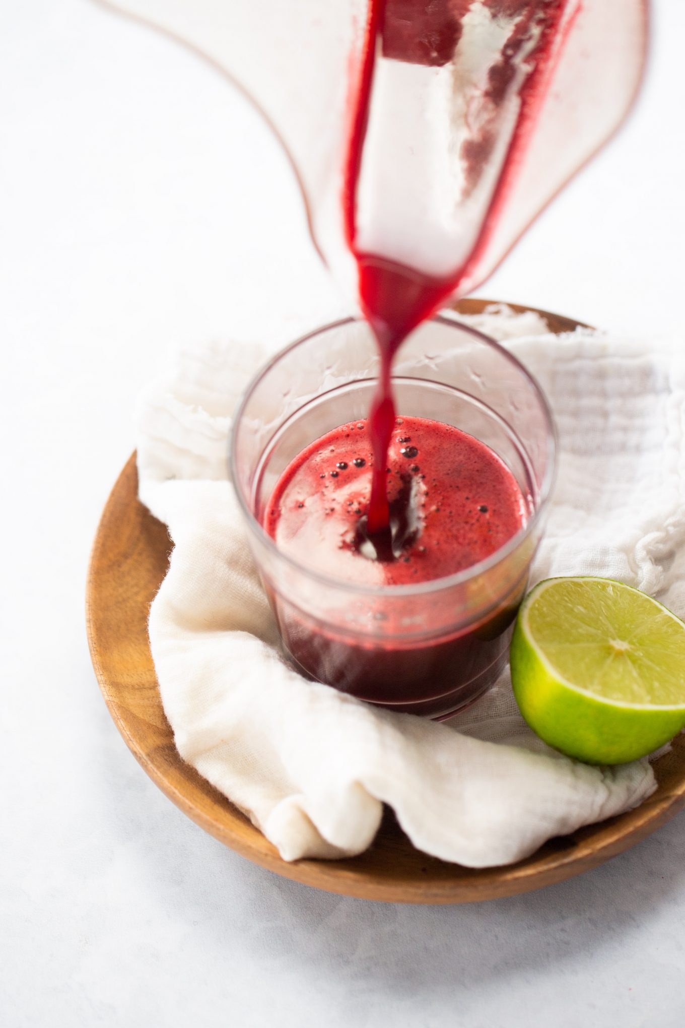 beet juice being poured into a glass