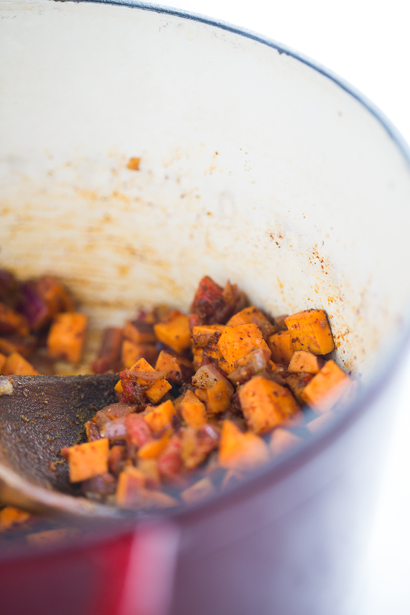 Sweet potatoes and aromatics in a pot for chili