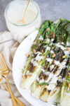 Roasted romaine lettuce with tahini dressing. Vegan grilled romaine salad.