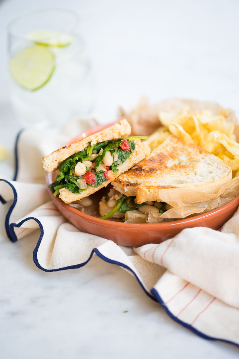 healthy vegan kale sandwich with chips on the side