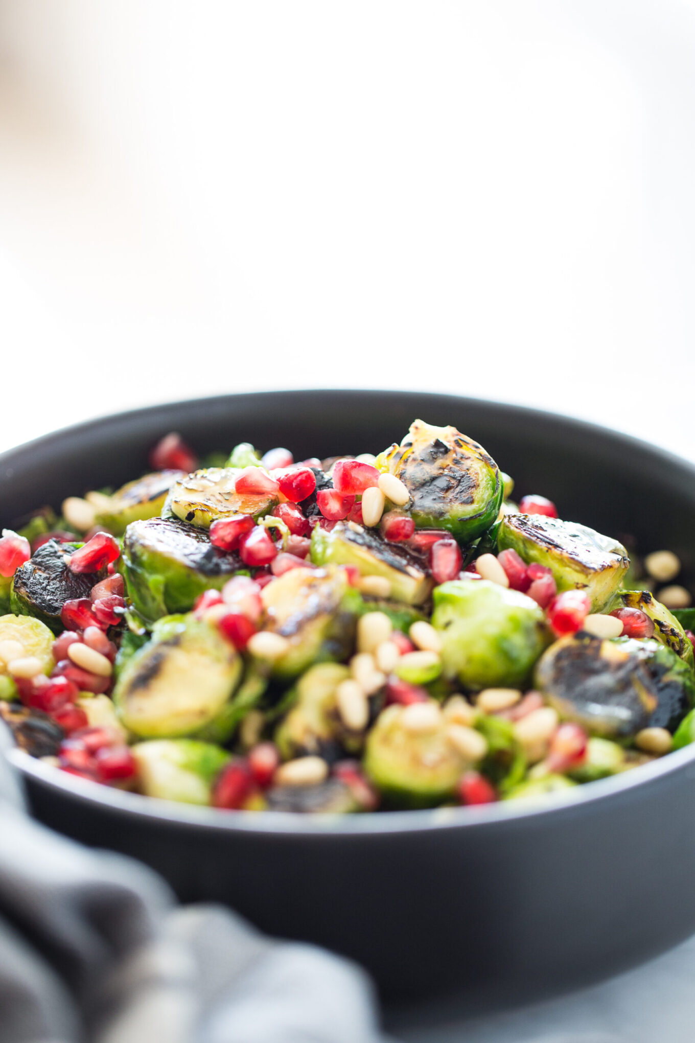 Roasted Brussels sprouts salad with agave Dijon mustard and topped with pine nuts and seeds. It is vegan and perfect for the Holidays.