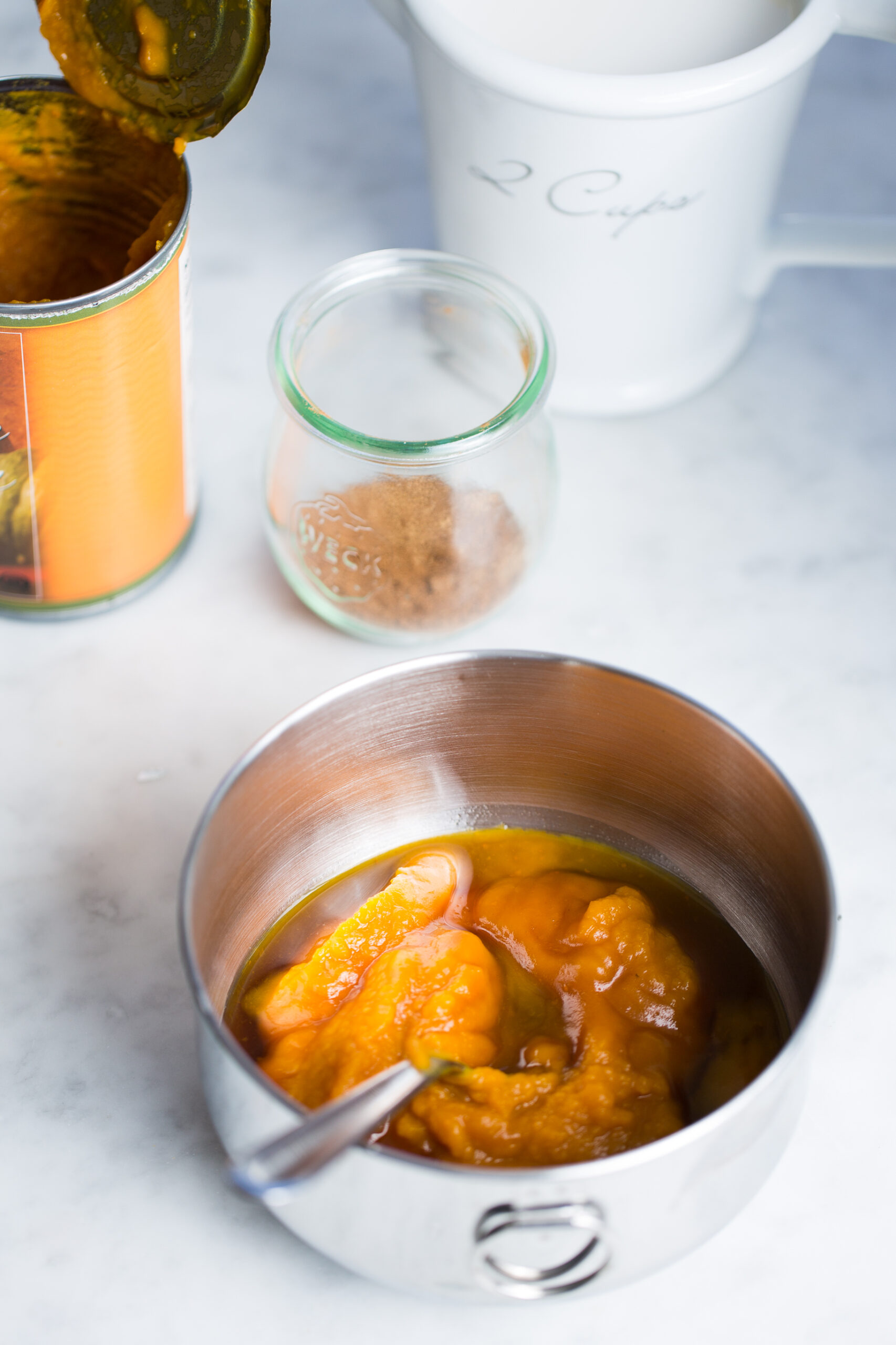 canned pumpkin n a bowl with other ingredients to make  baked oats casserole