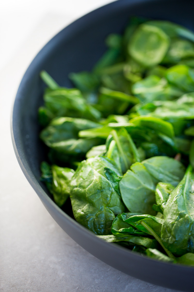 dark bowl with fresh spinach
