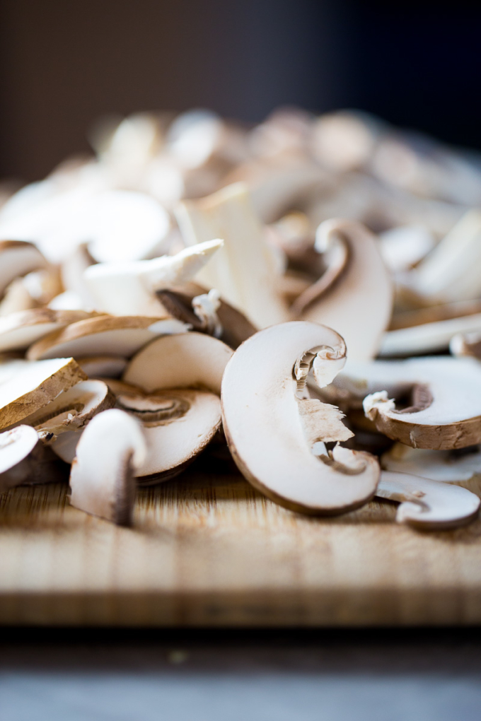sliced mushrooms over a cutting board