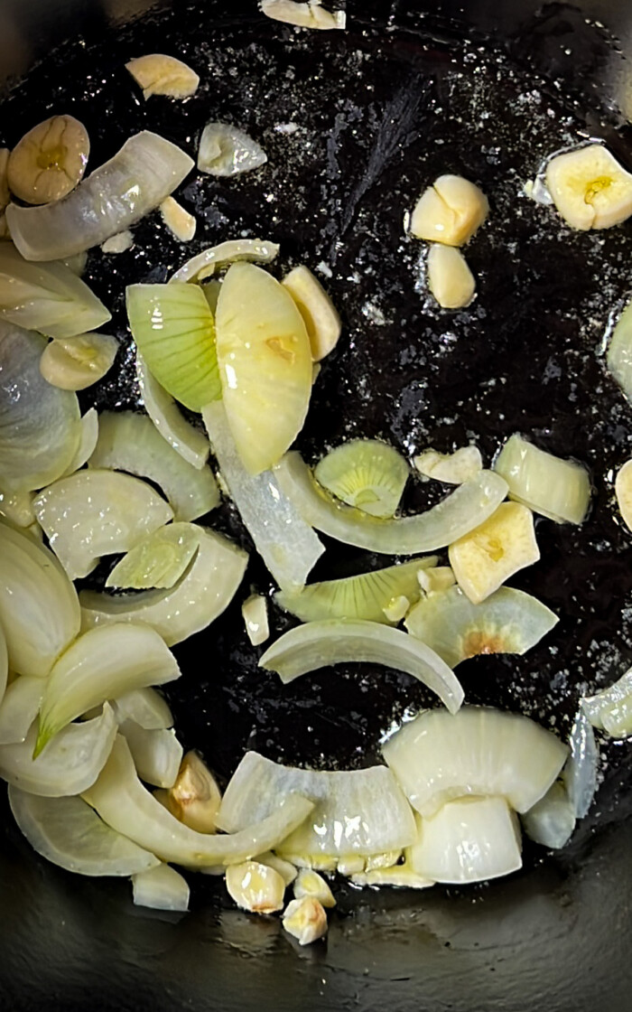 onion and garlic on a pot being sautted