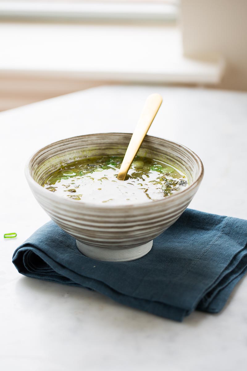 bowl of split pea soup with fresh herbs