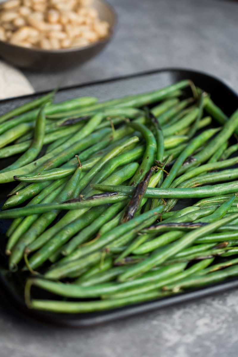 Green beans roastin on a griddle over the stove