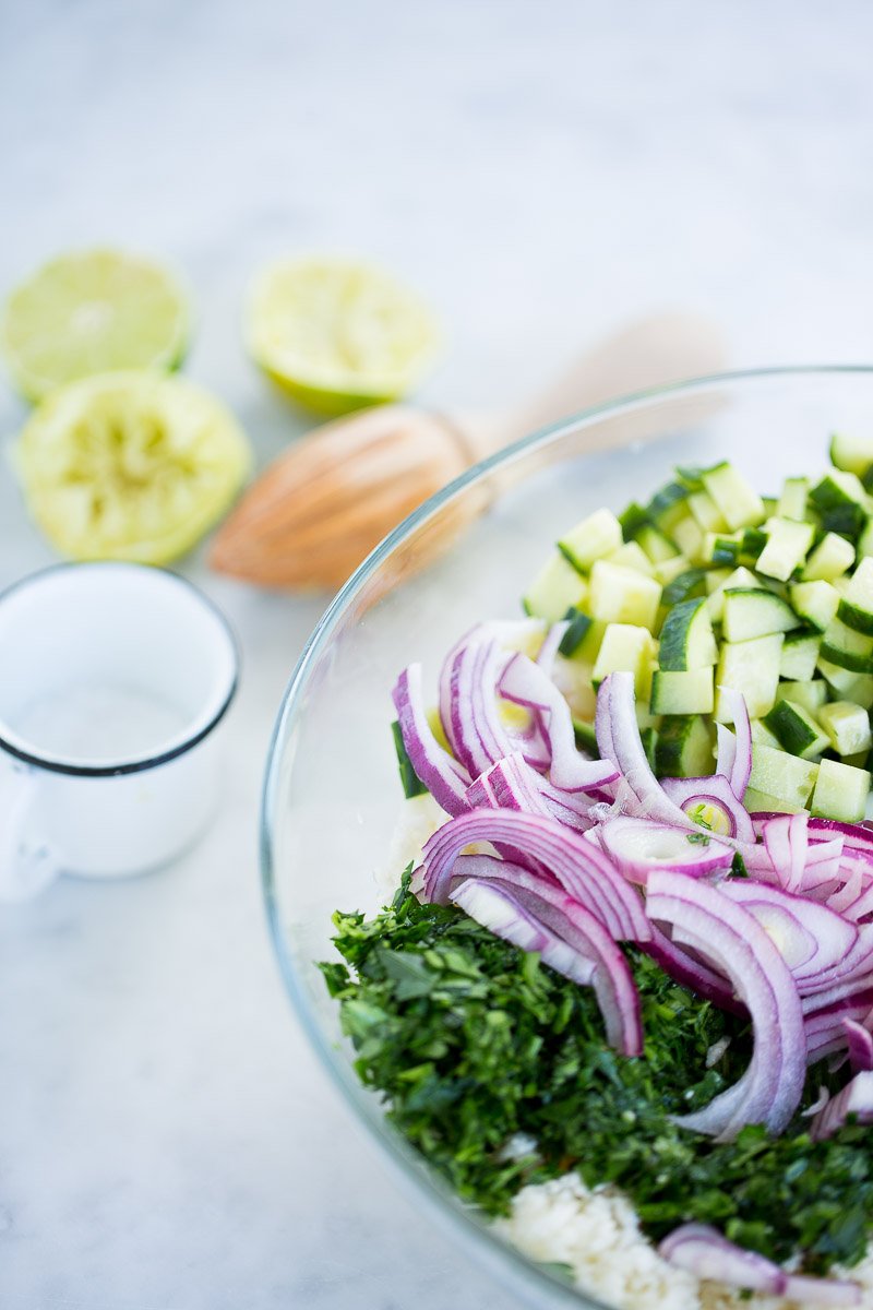 bowl of raw cauliflower, parsley, red onion and cucumber