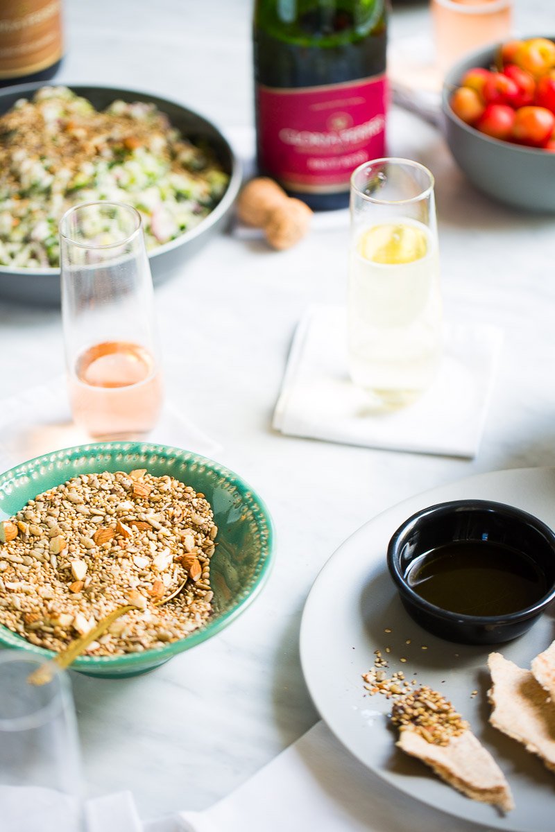 bowl of dukkah next to a bowl with olive oil and pita bread