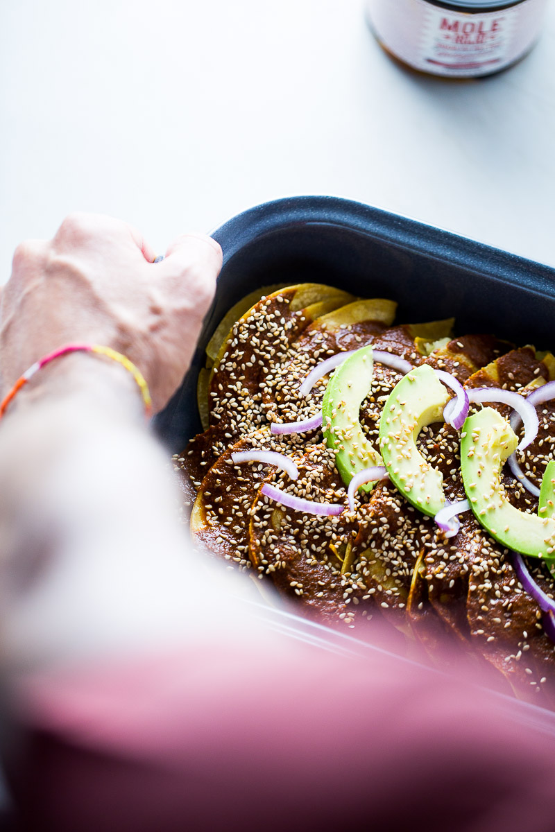 vegan mole enchiladas in a grey peltre baking dish