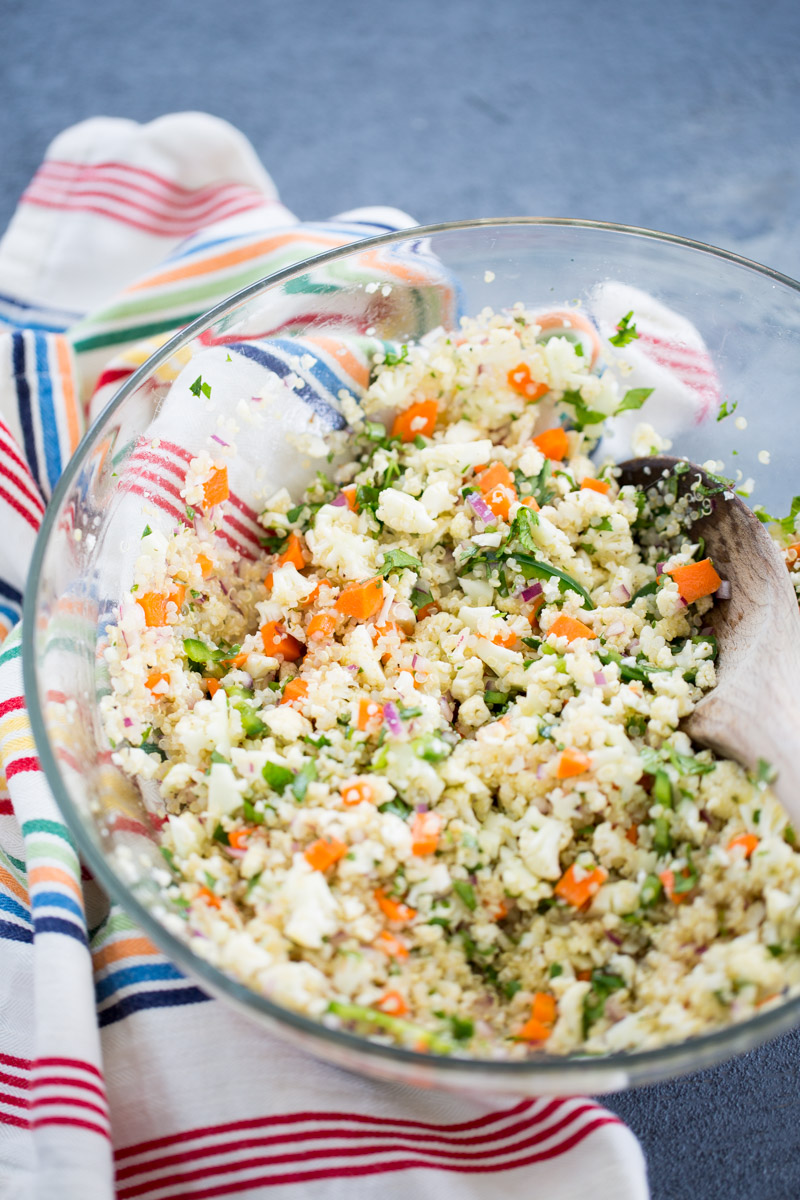 Quina, cauliflower florets, lime juice, chile and onion mixed in a glass bowl to make tostadas de ceviche