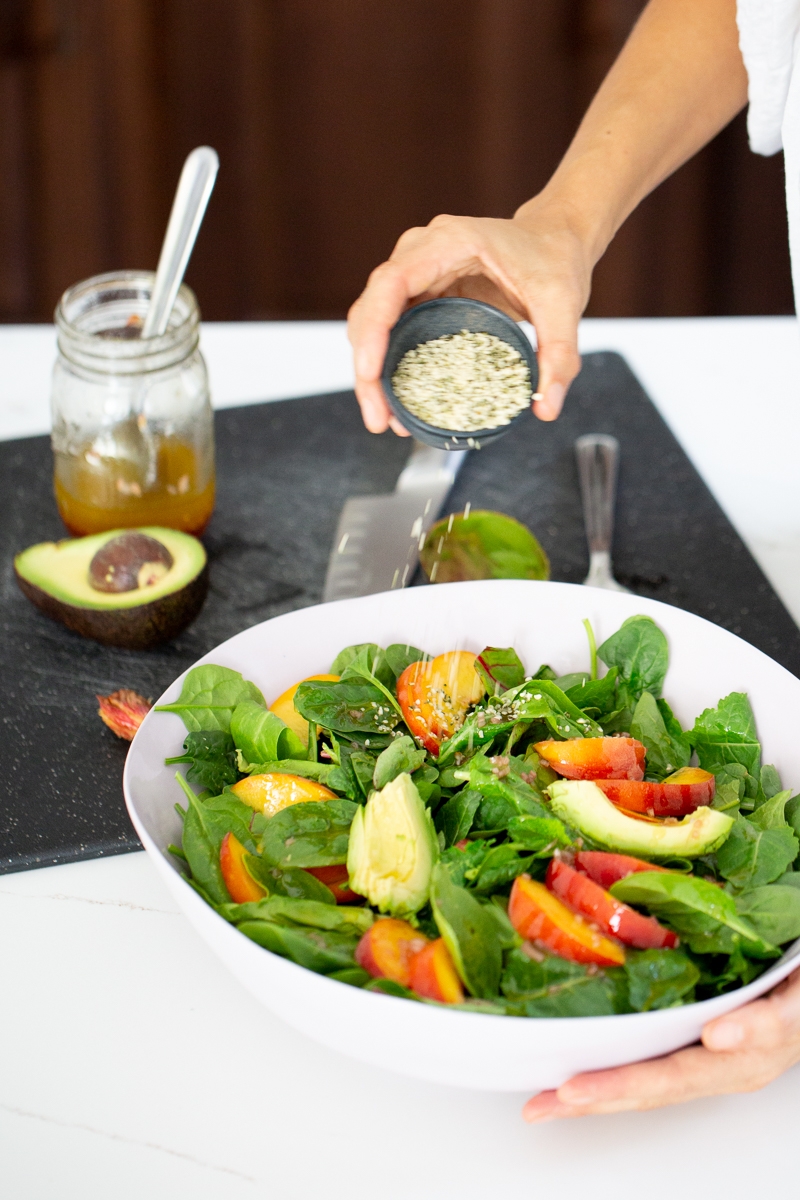 finishing up a peach and avocado summer salad