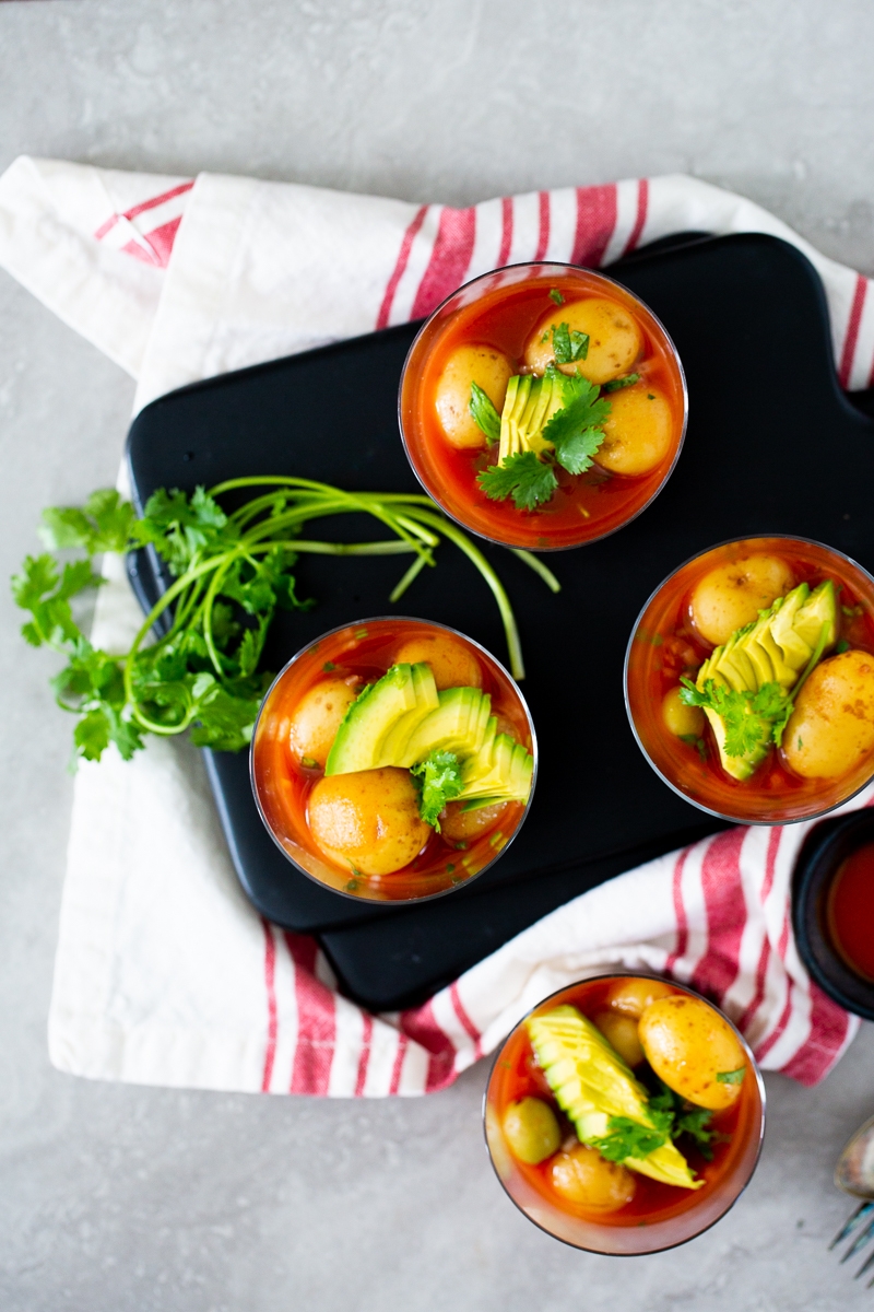 Potato ceviche Veracruz in small glasses and topped with avocado and cilantro