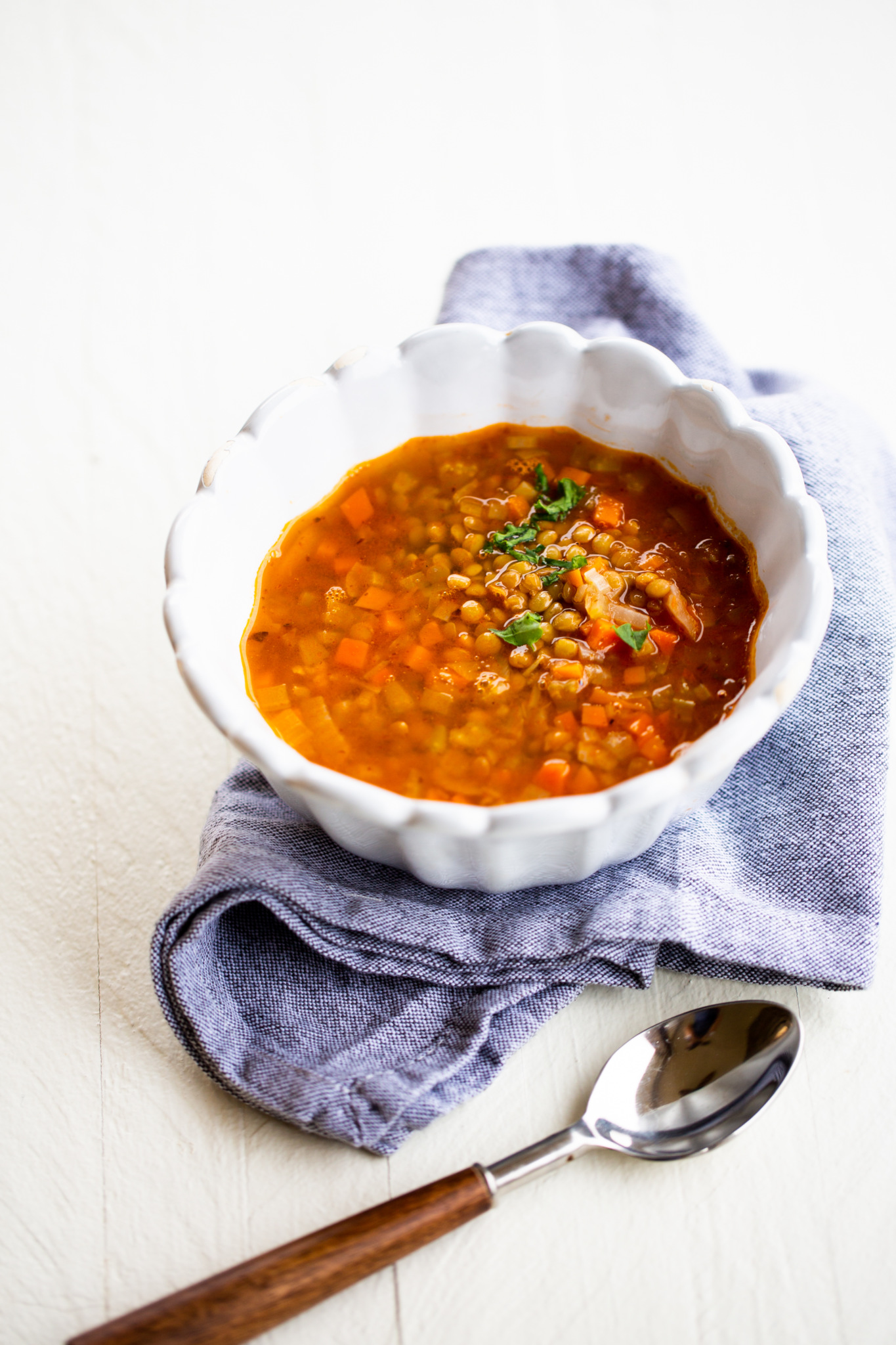 Mexican lentil soup, sopa de lentejas in a white bowl.