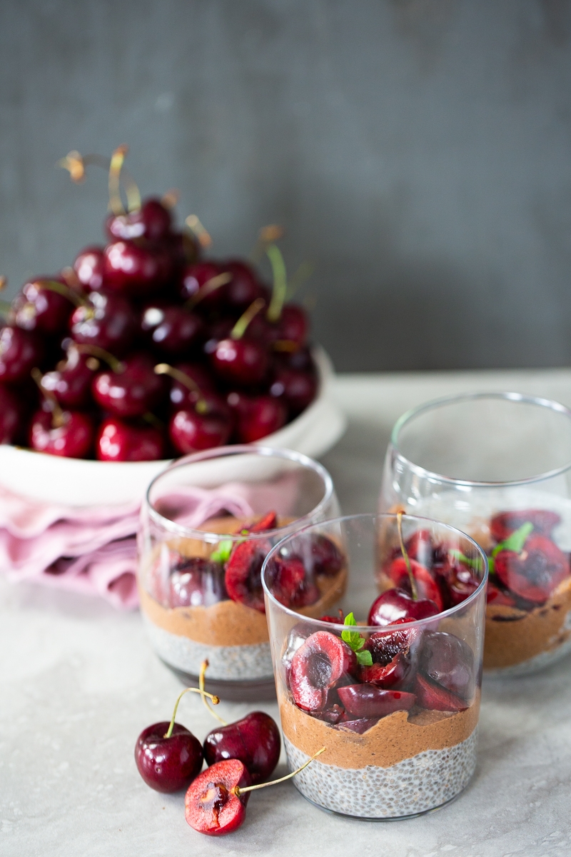 Three layer chia pudding, vegan vanilla and chocolate chia pudding topped with cherries.