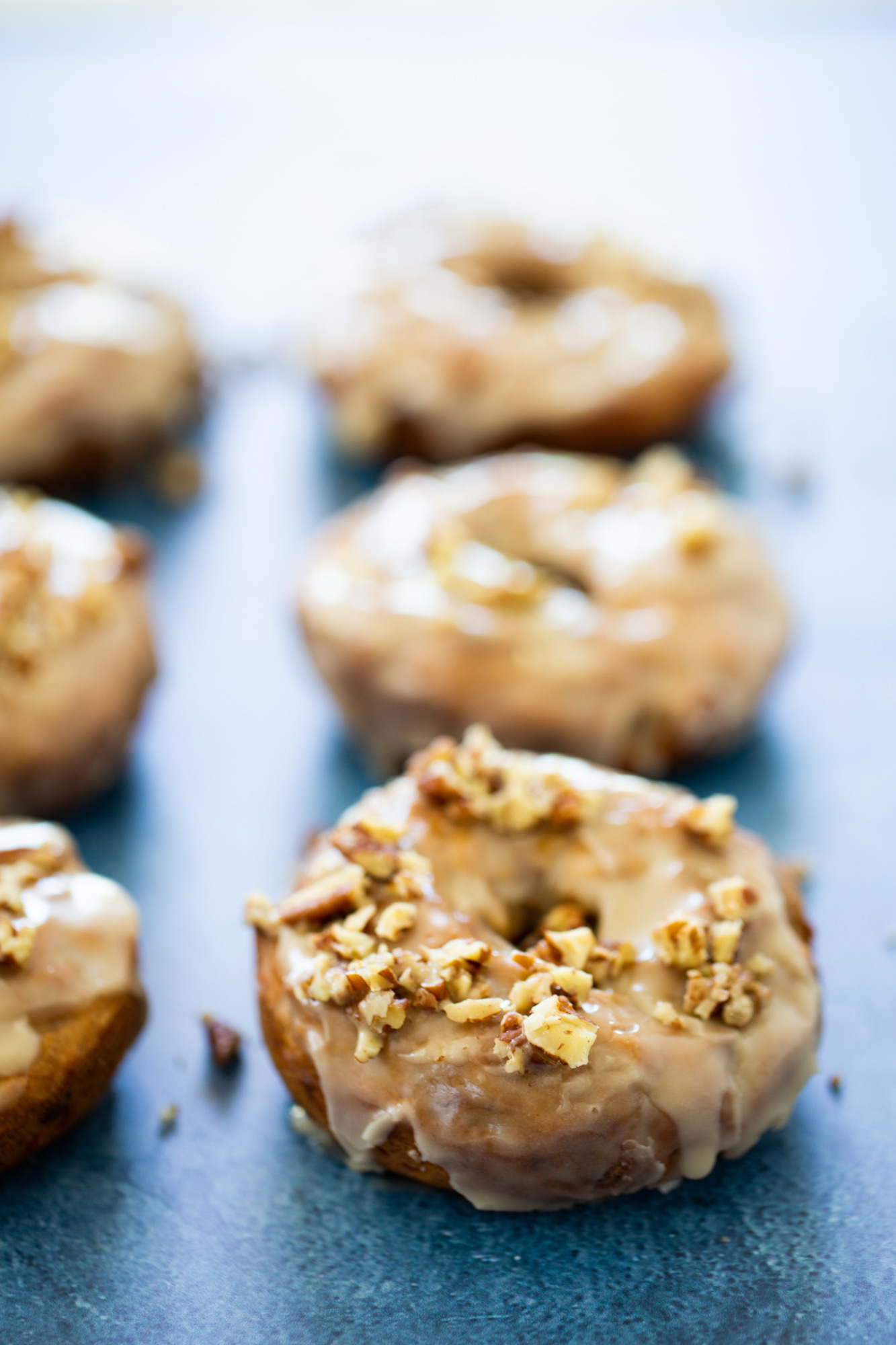 vegan donuts with maple glacé and chopped nuts