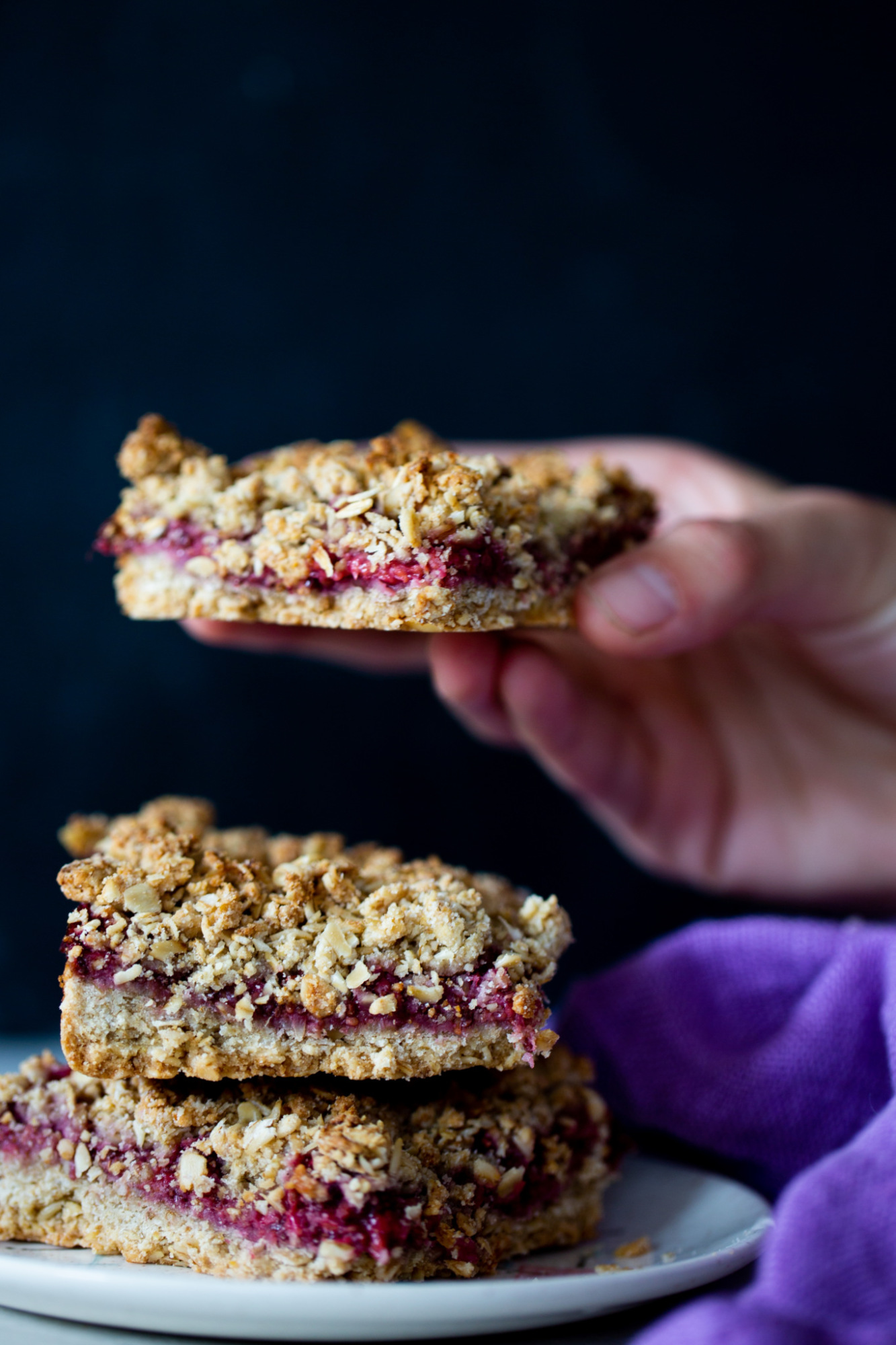 an oatmeal bar held by a kid.