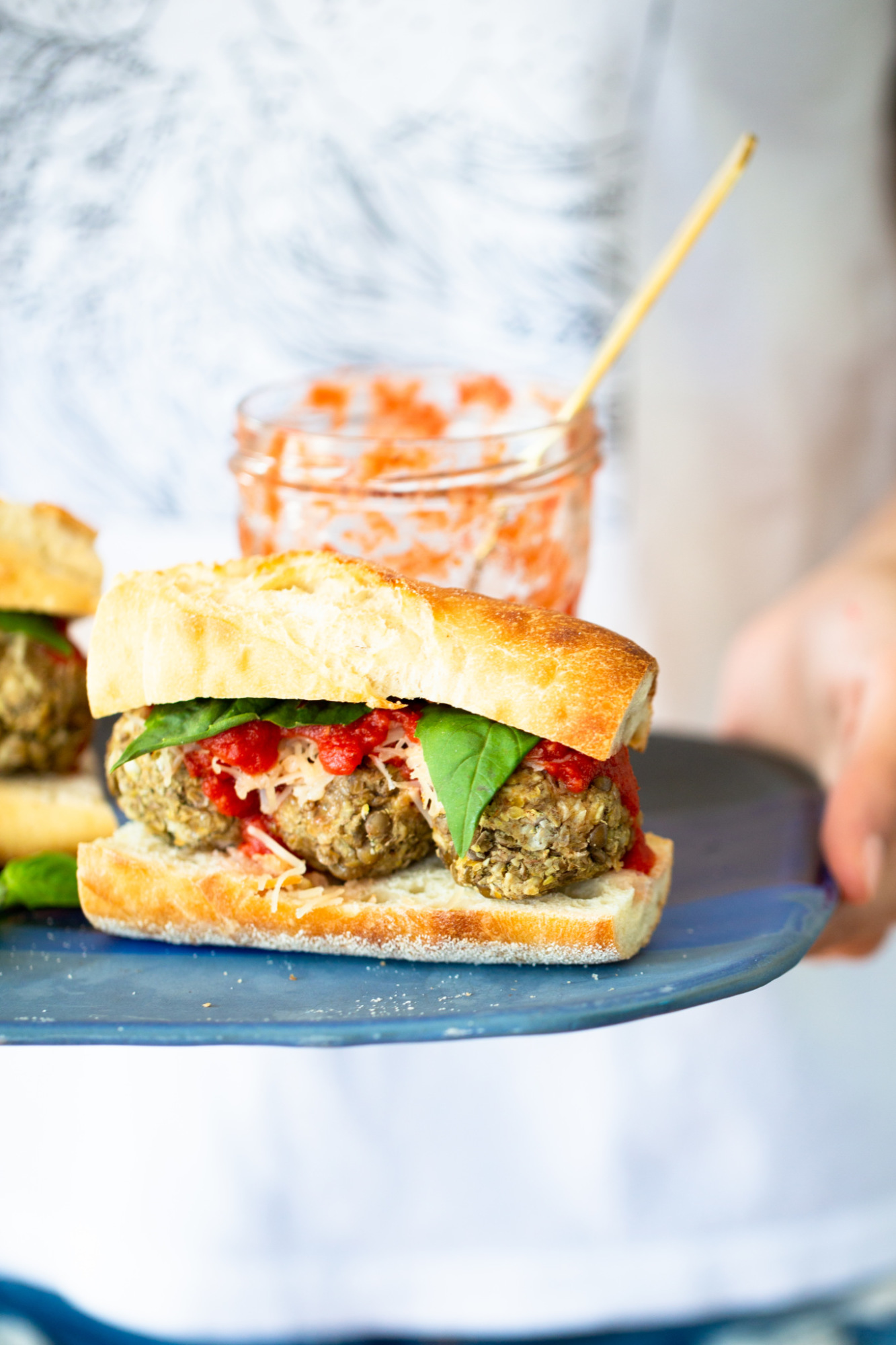 Vegan meatball sub on a blue platter.