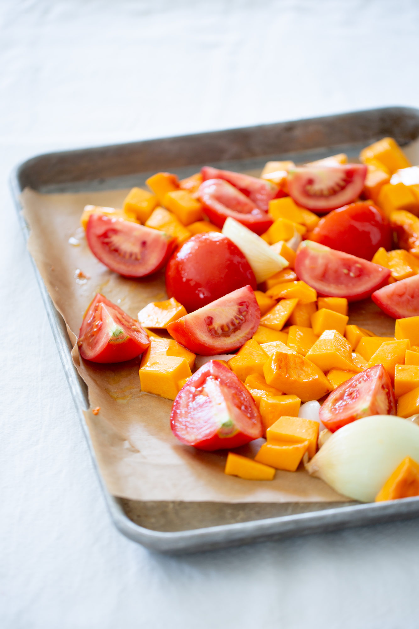 tomatoes, butternut squash, and onions before roasting