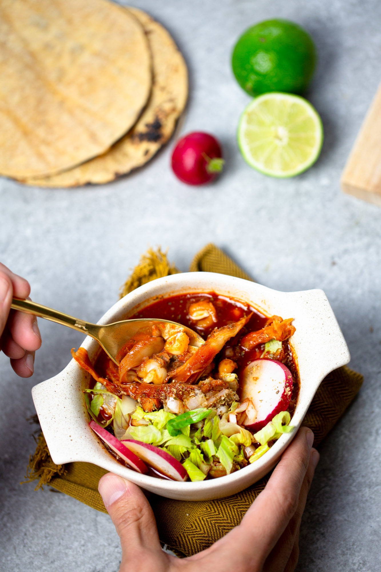 A person holding a bowl of vegan Mexican food.