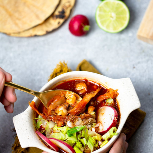 A person holding a bowl of vegan Mexican food.