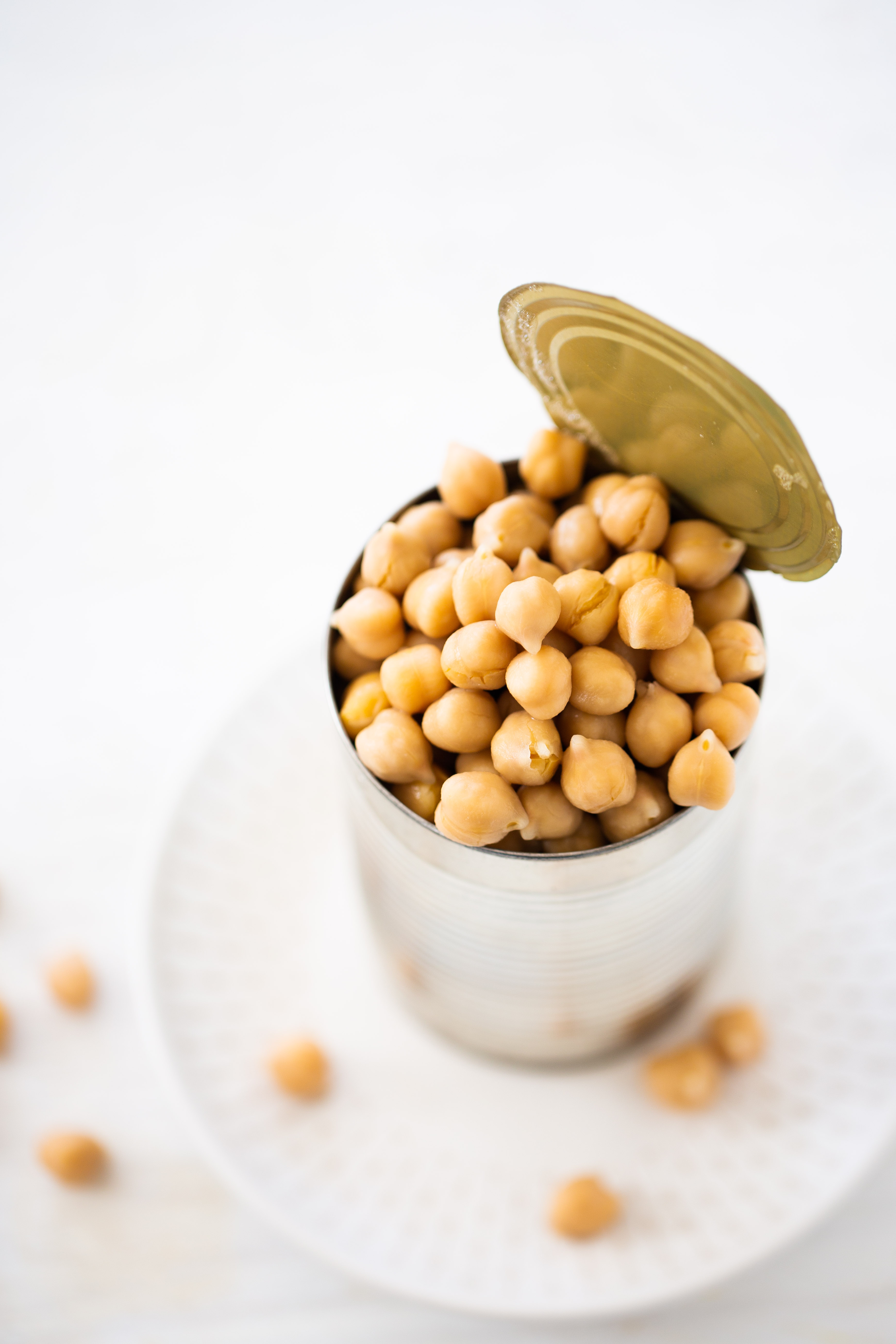 A can of chickpeas on a white plate.