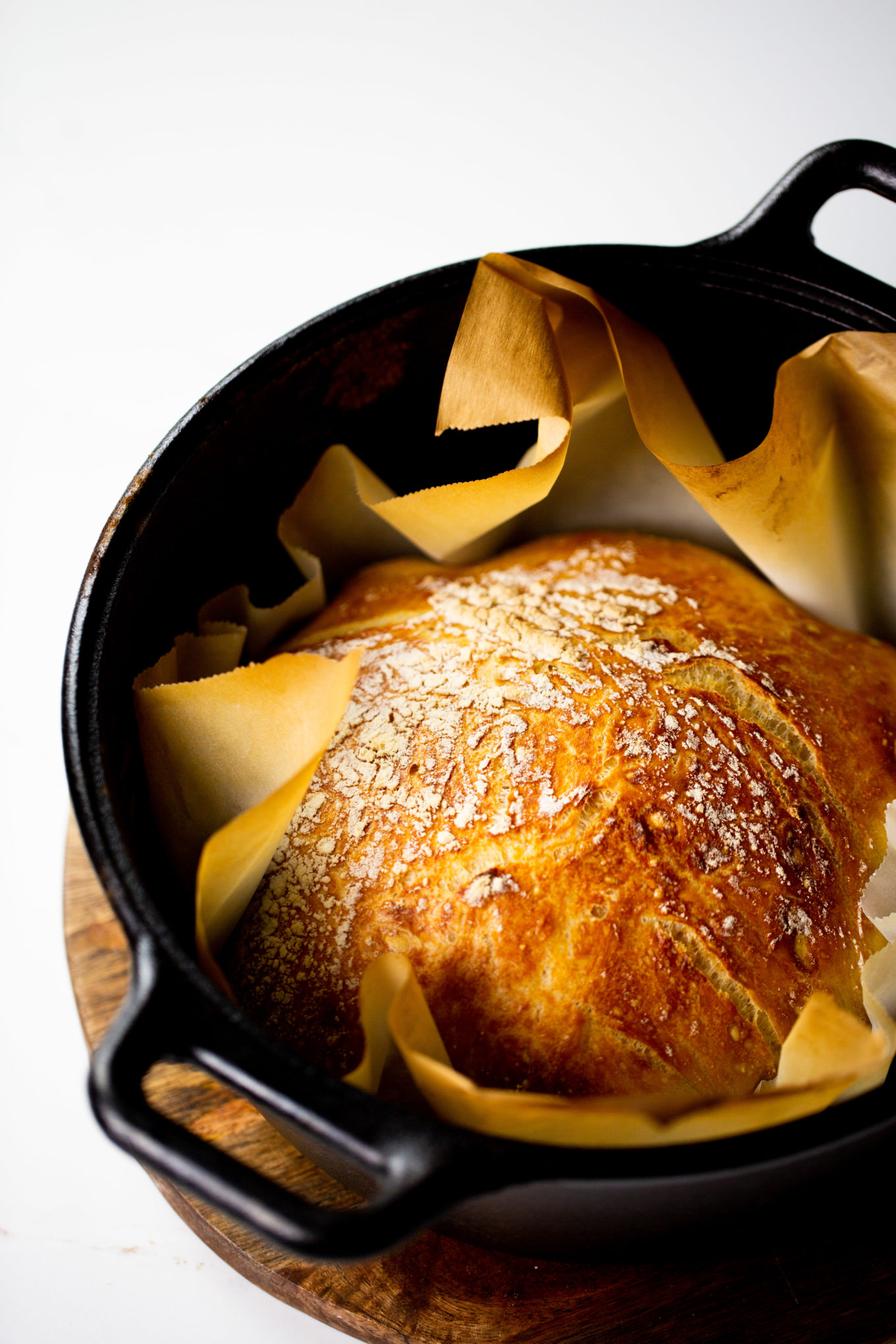 A loaf of bread in a cast iron pan.