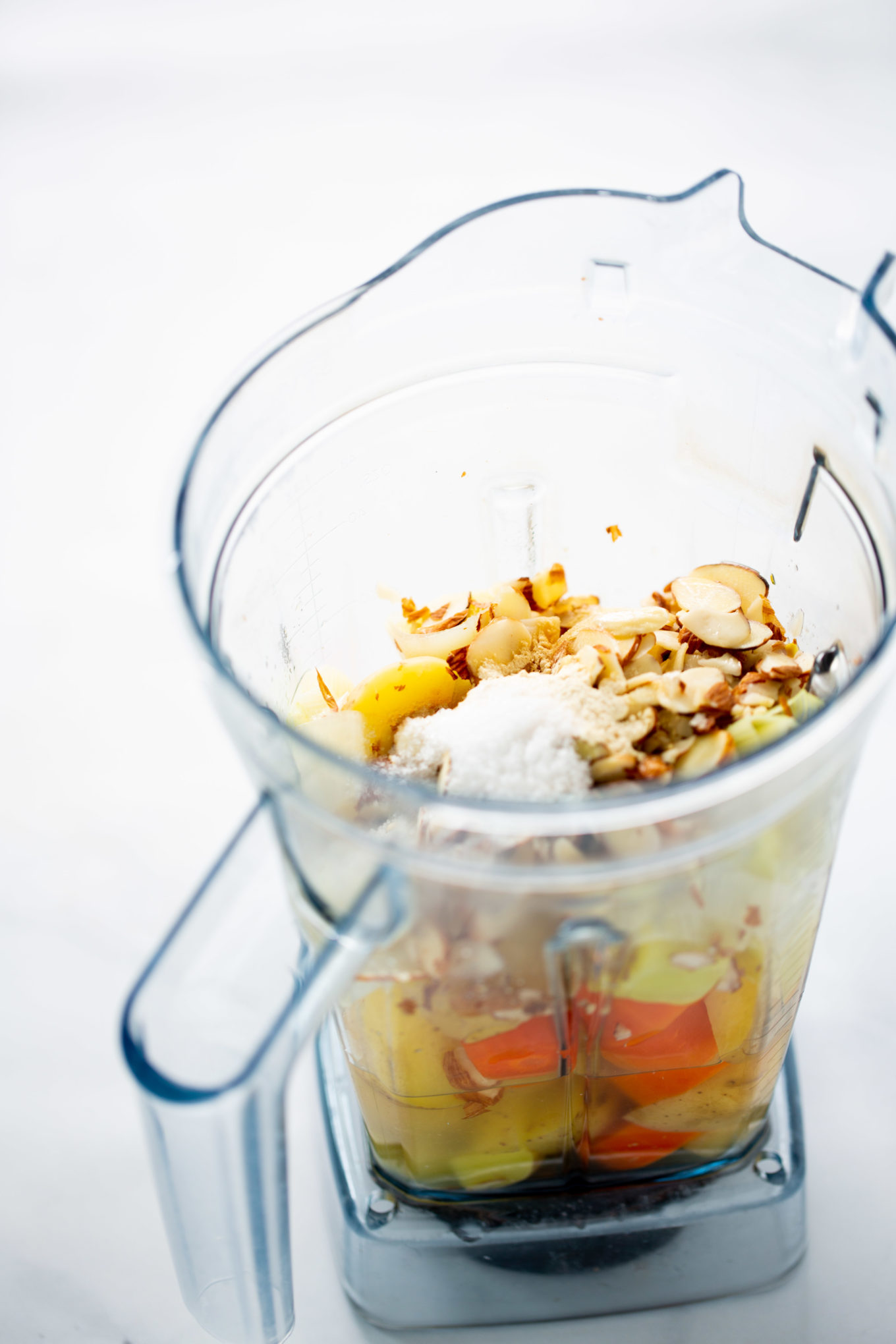 Carrots, potatoes and almonds in the blender container