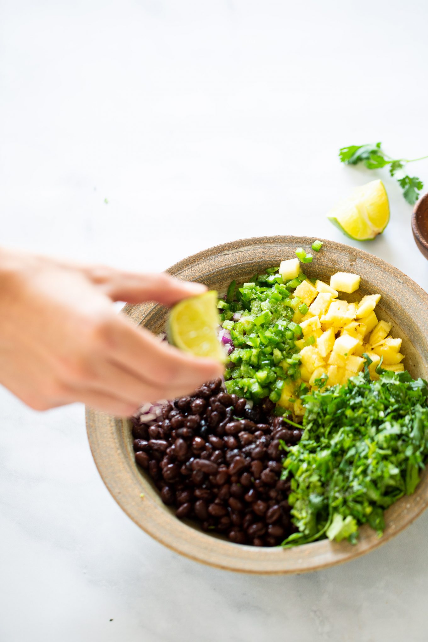 Seasoning with lime juice a pineapple pico de gallo