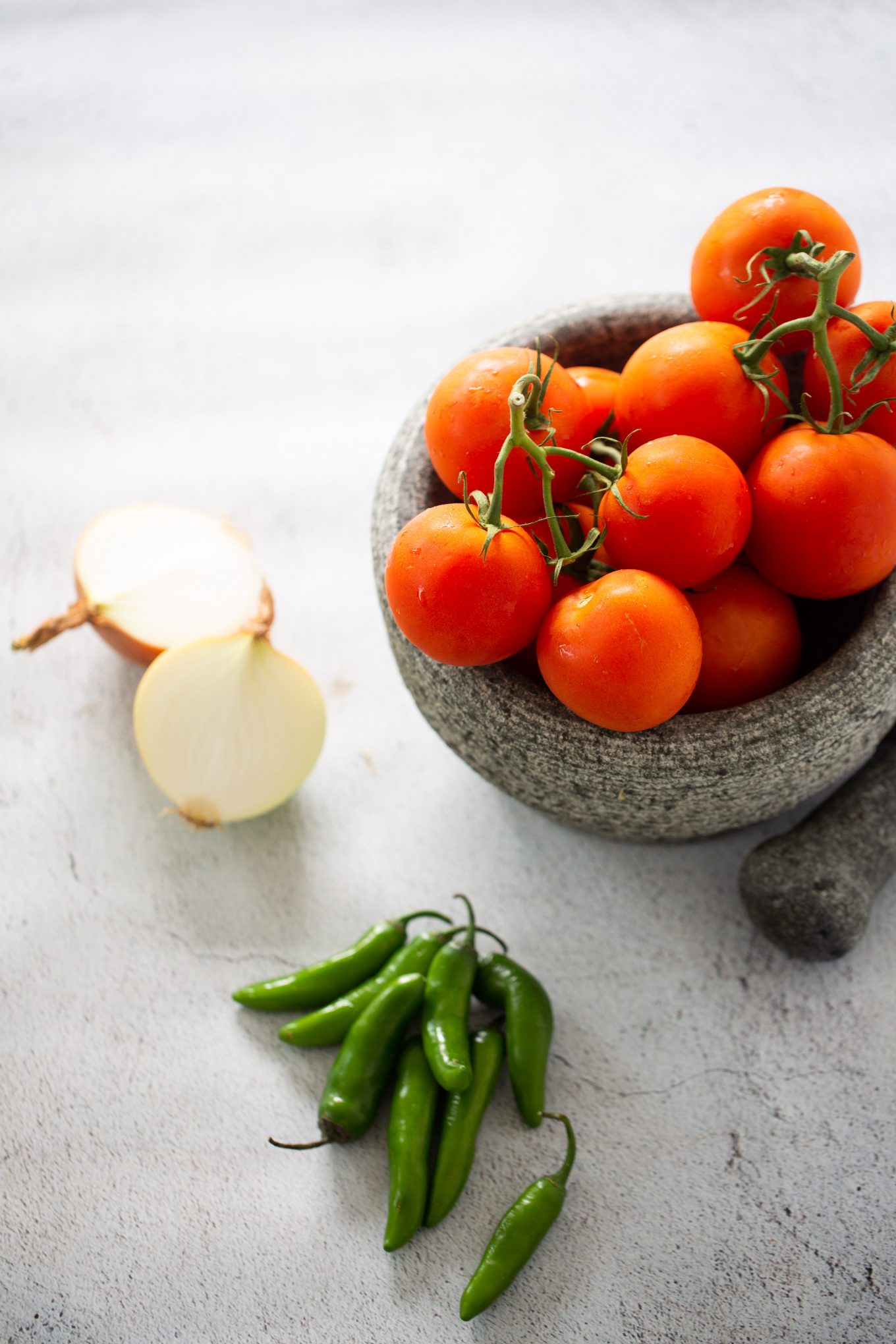 ingredients to make red salsa with a molcajete