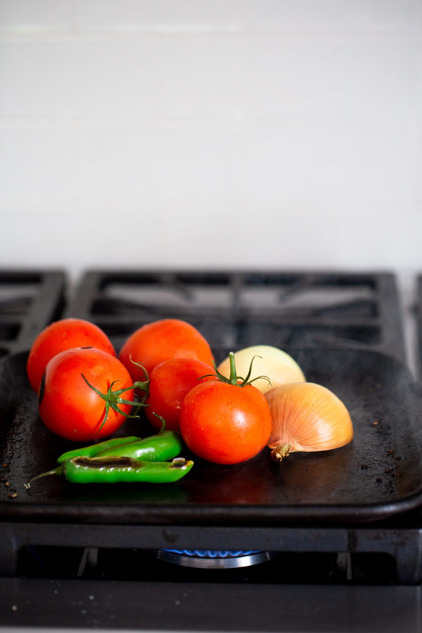 ingredients on the grill, tomato onion and serranos