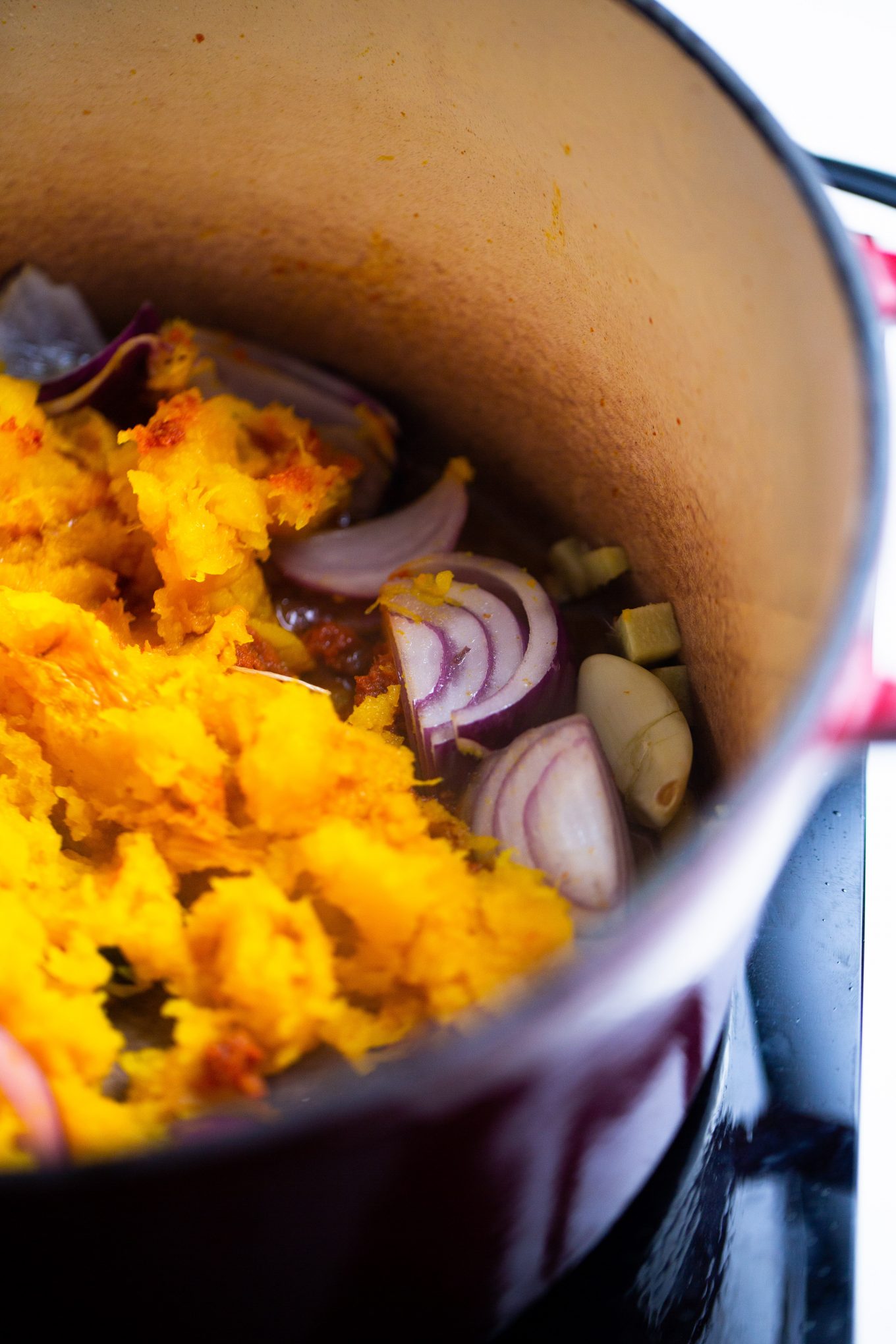 kobocha and aromatics in a pot for soup