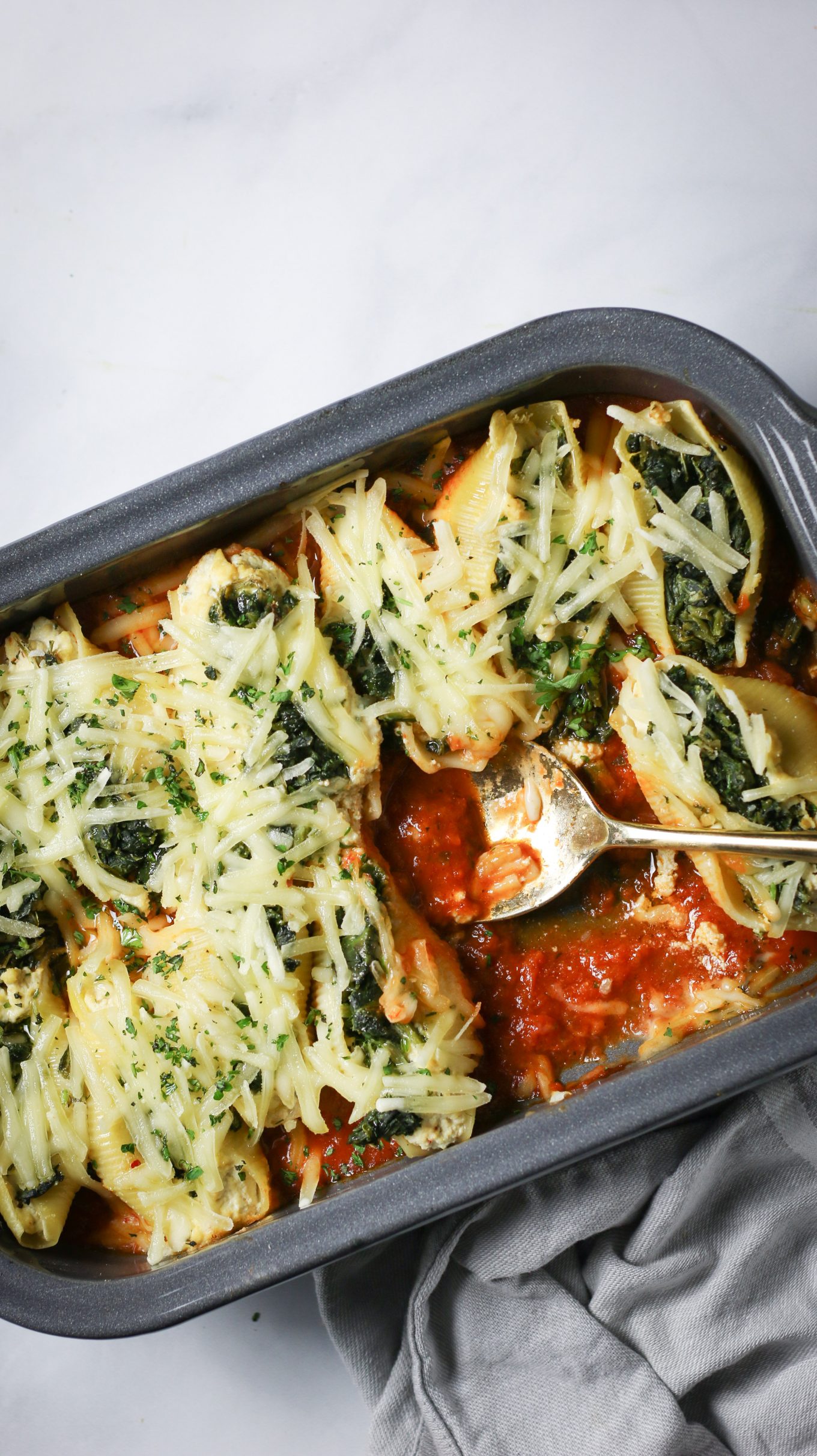 Vegan stuffed shells with spinach and cheese in a baking dish.