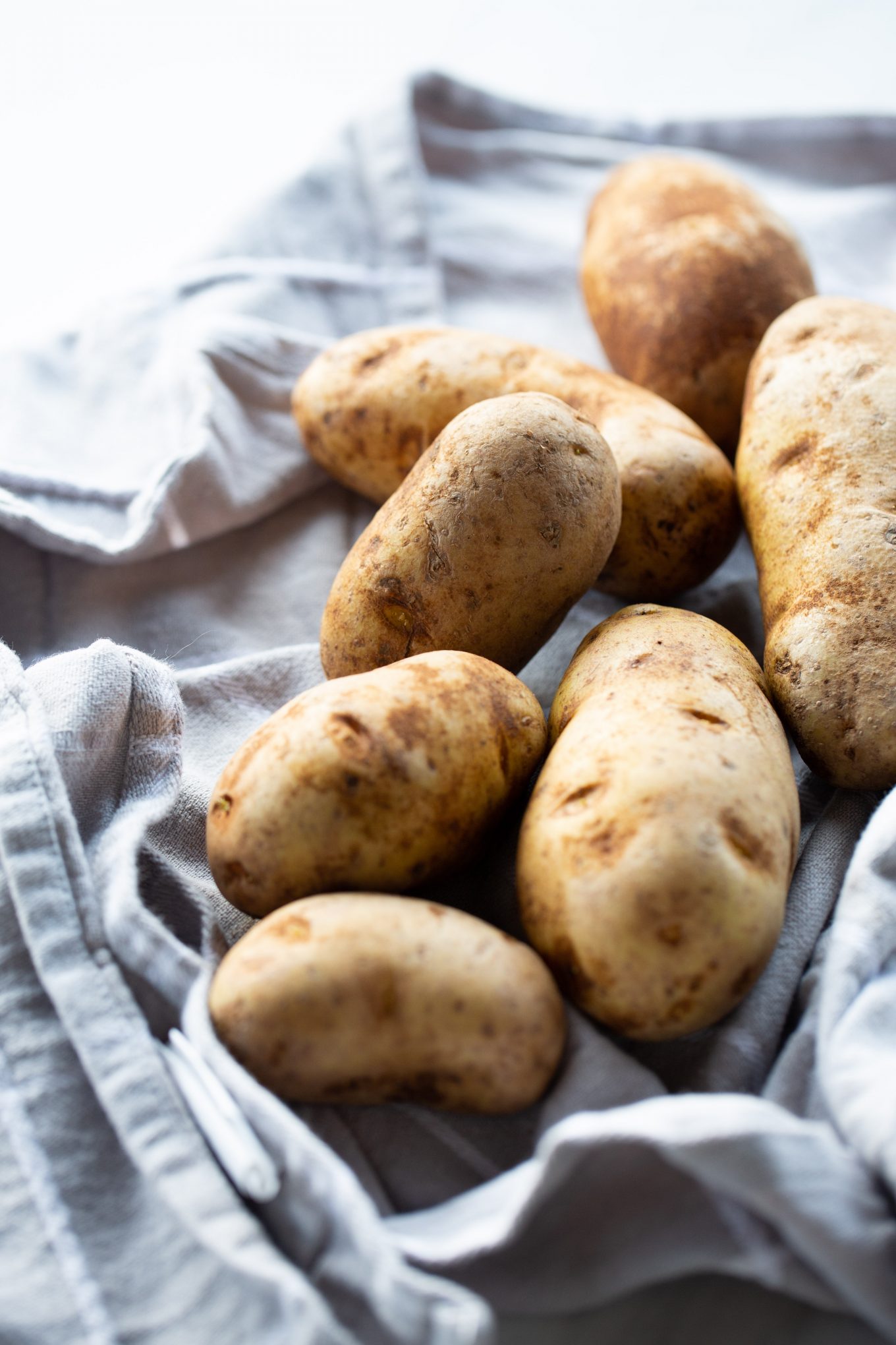 russet potatoes over a gray kitchen cloth