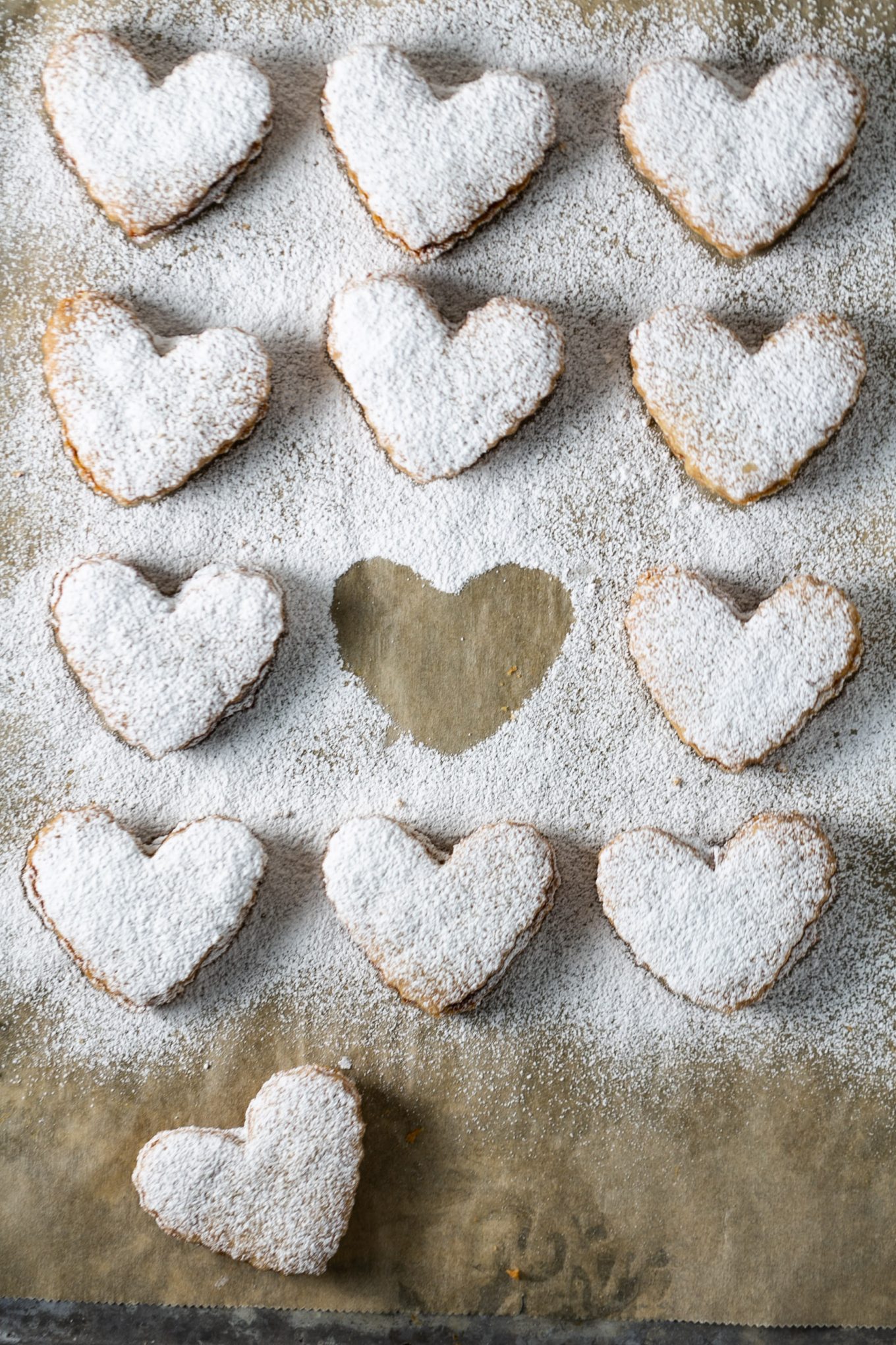 Vegan butter pecan cookies sandwiches dusted with powdered sugar