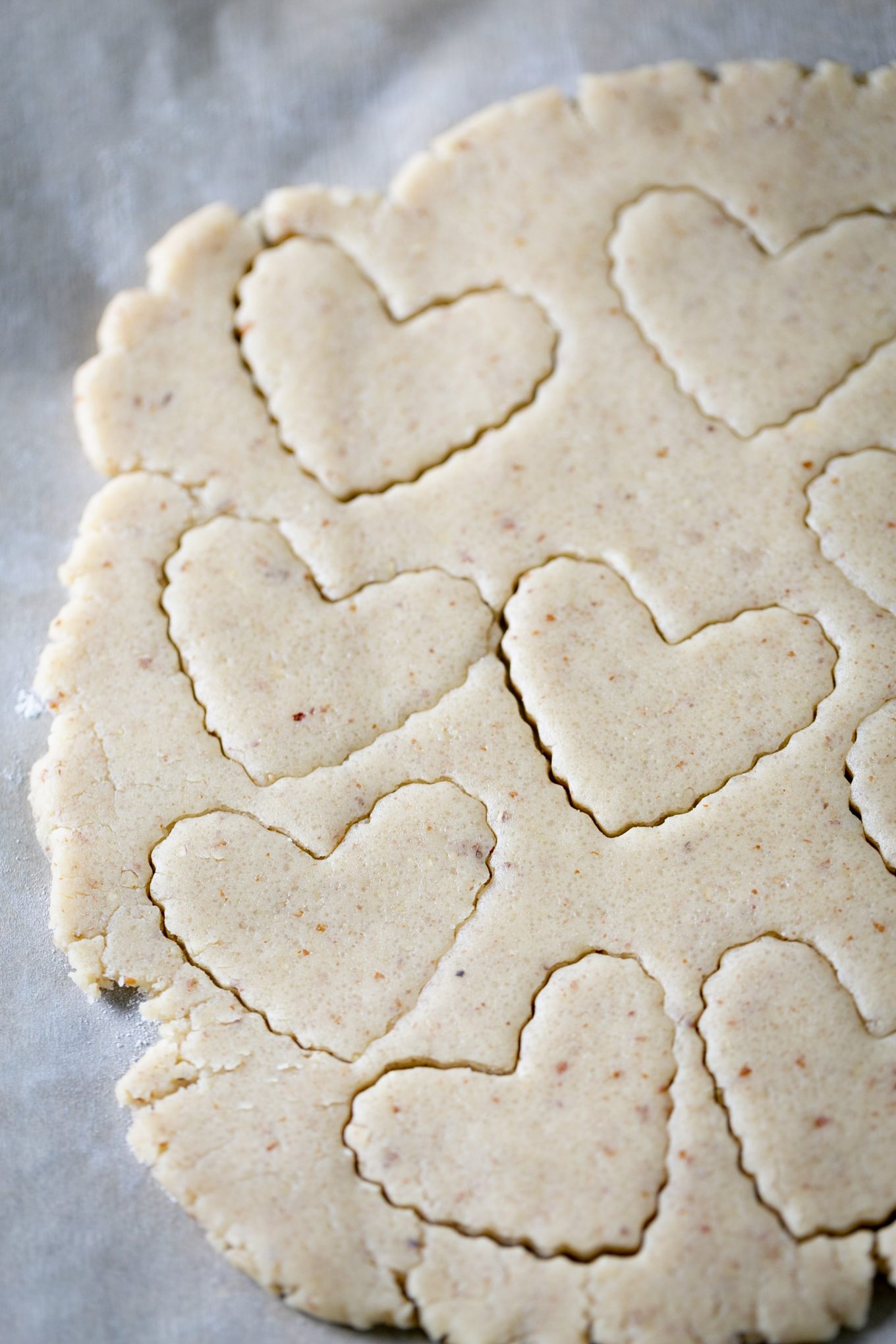 rolled dough ove a piece of parchemnet paper and hearts