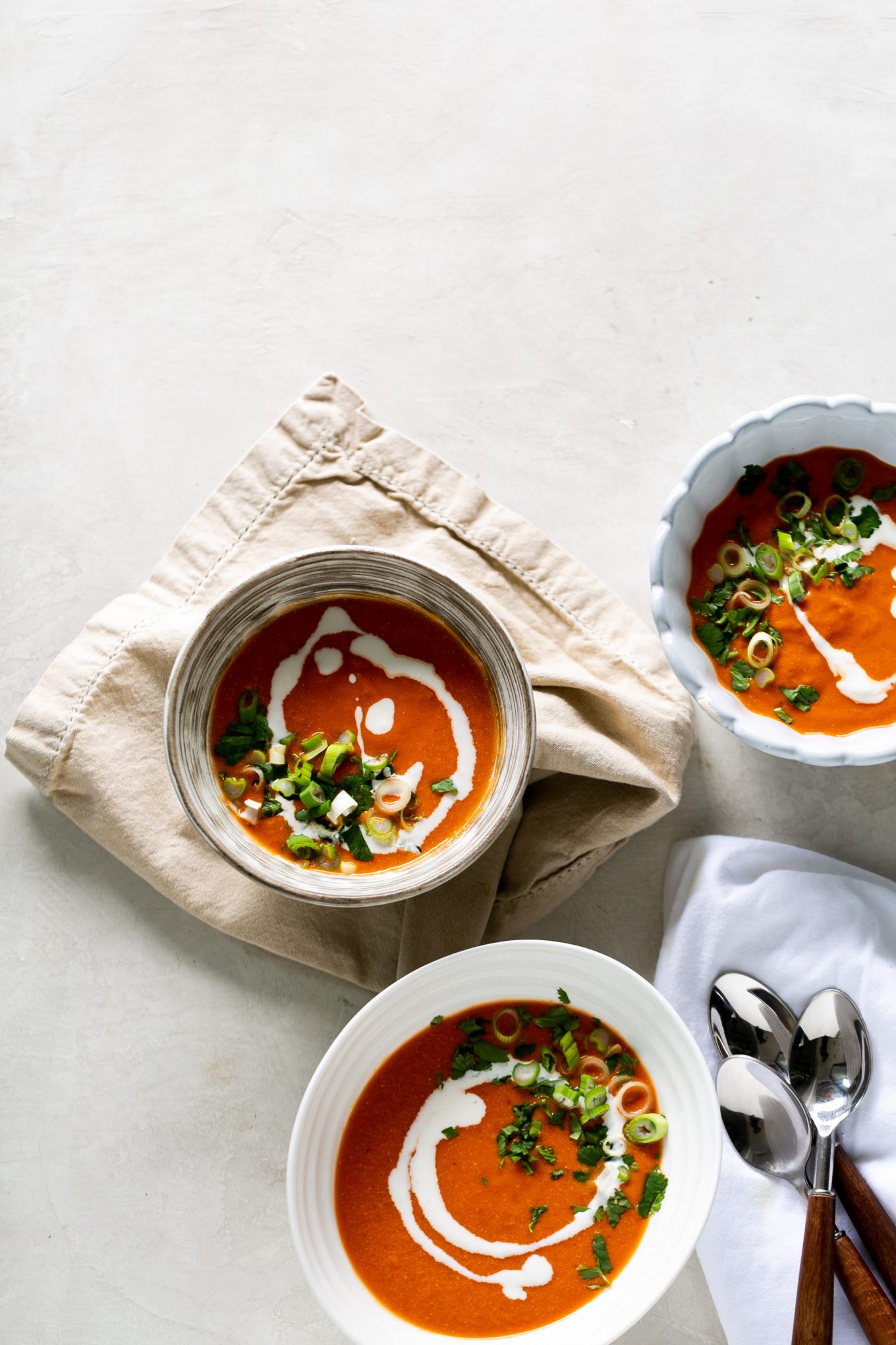 Three bowls of spicy creamy vegan tomato soup