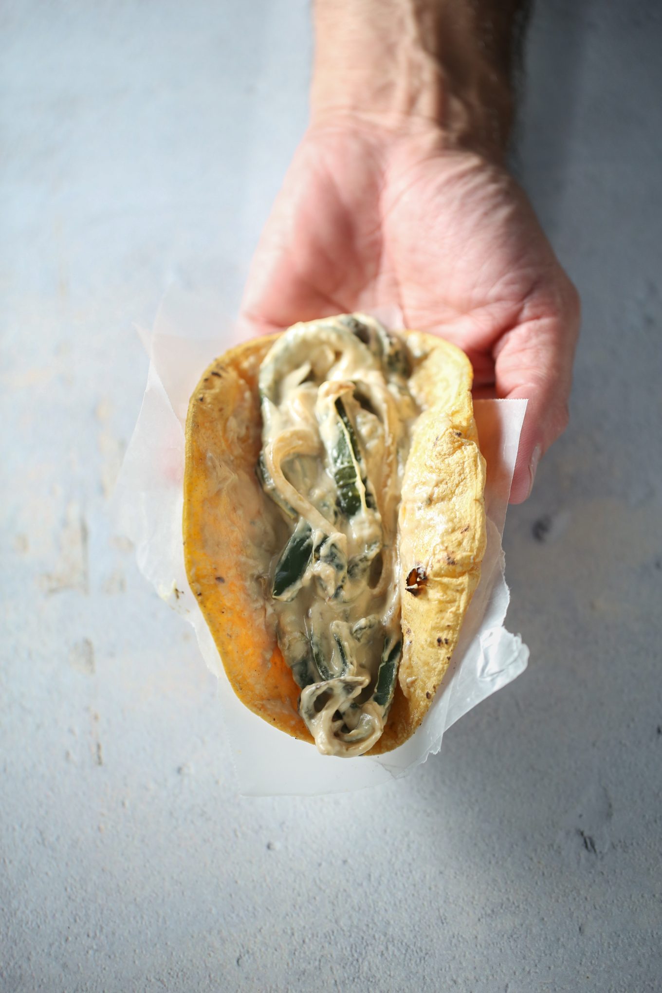 Rajas con crema taco in a corn tortilla