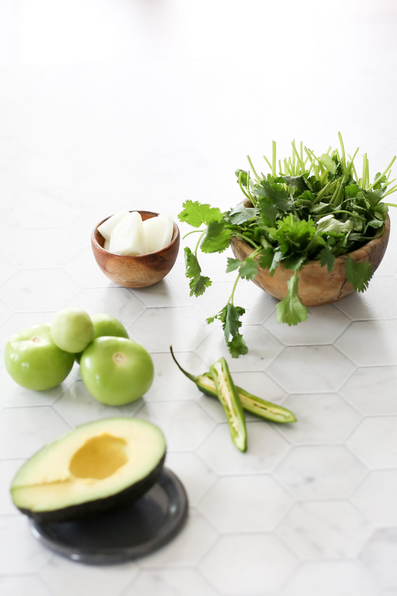 Ingredients to make creamy salsa verde: cilantro, onion, tomatillo, serrano